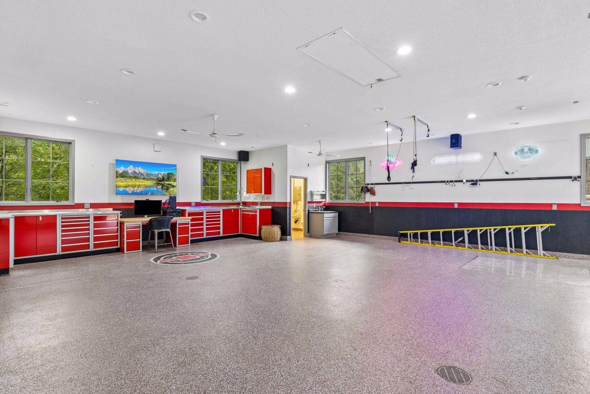 Space for the whole collection: a detached six-car garage complete with a half bath, custom workshop, epoxy flooring, and additional naturally lit attic storage space