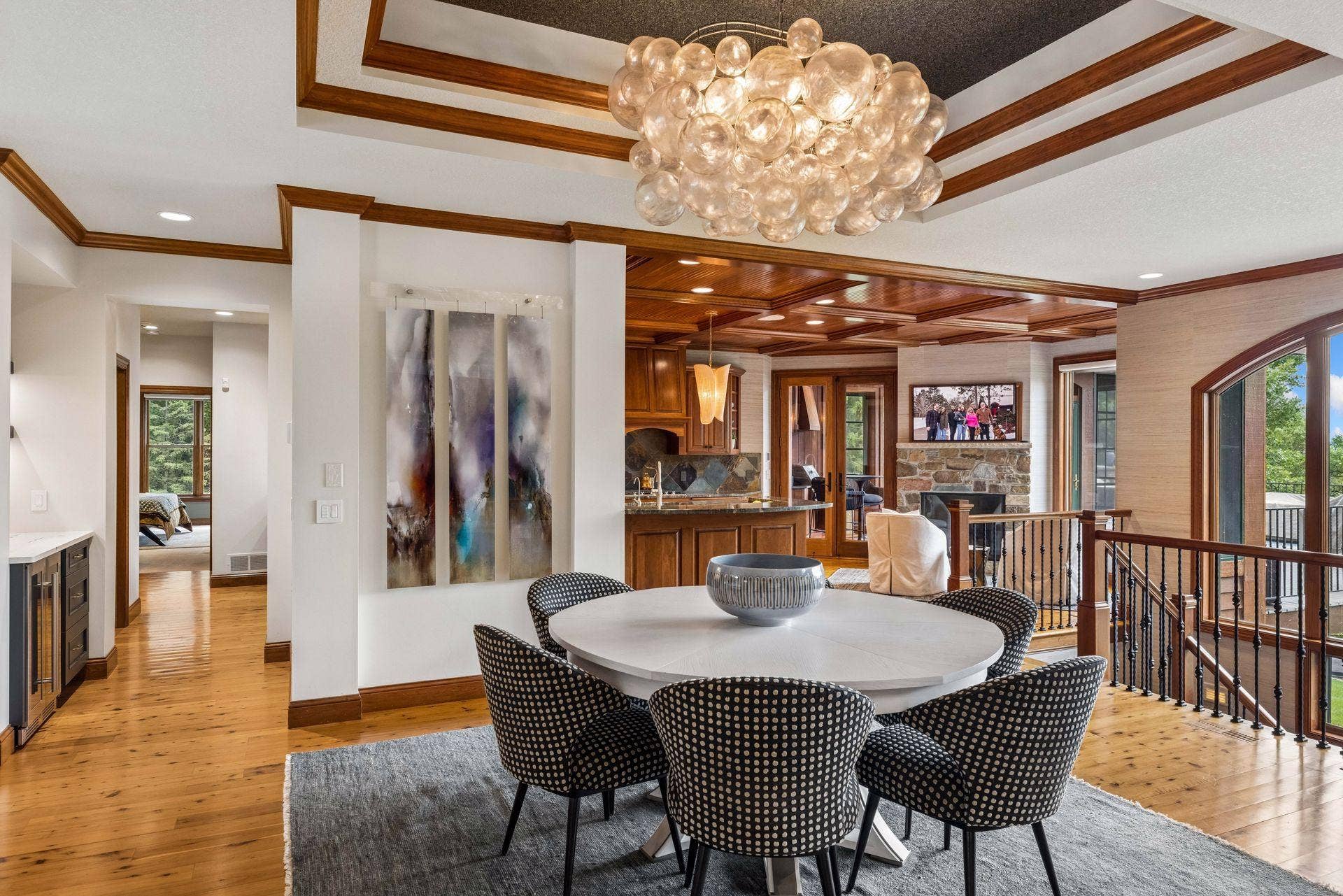 A custom tray ceiling, designer chandelier, and built-in bar set the stage for elegant dining, with St. Croix views just beyond