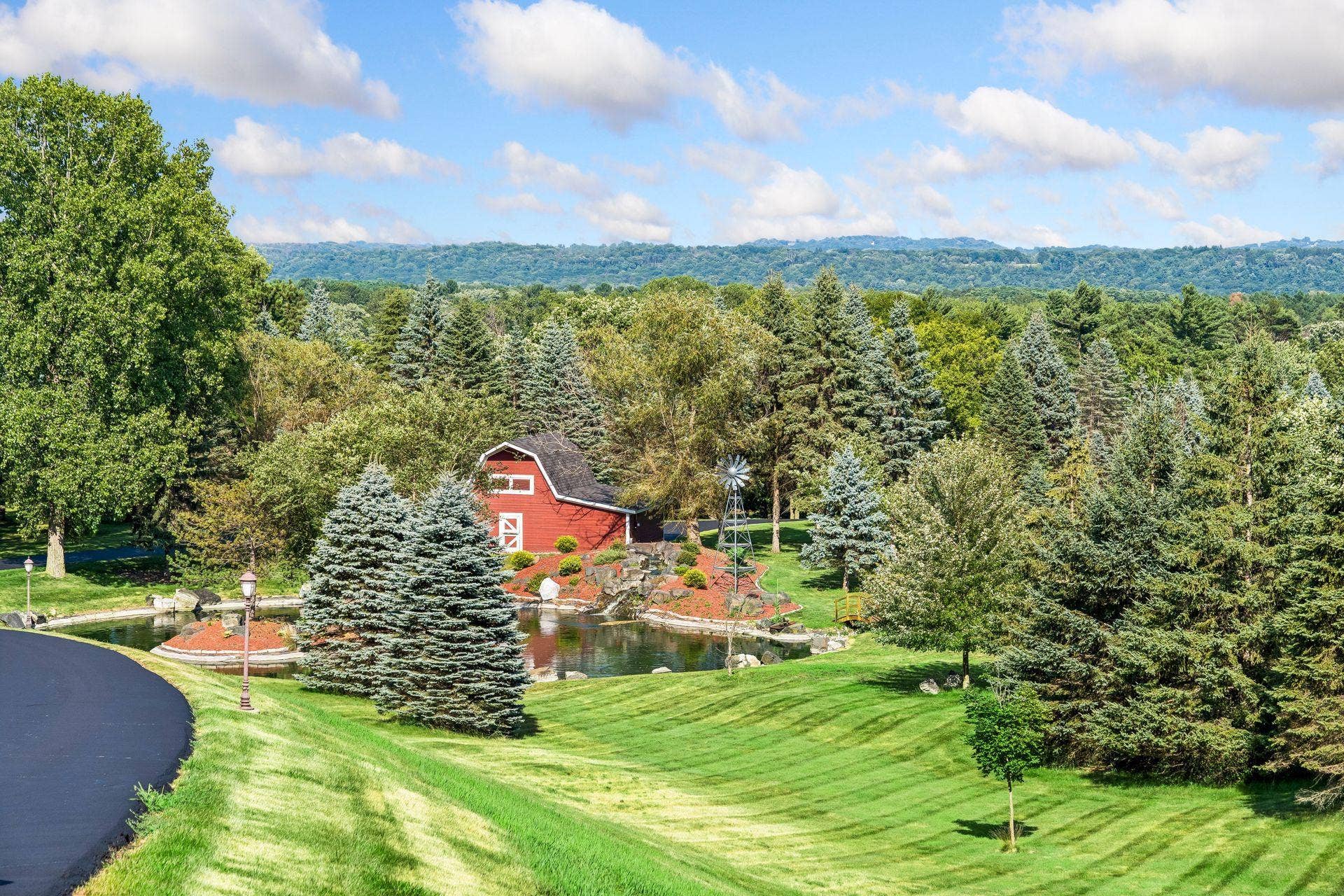 Historic Civil War era barn and private pond, framed by evergreens and rolling St. Croix Valley hills