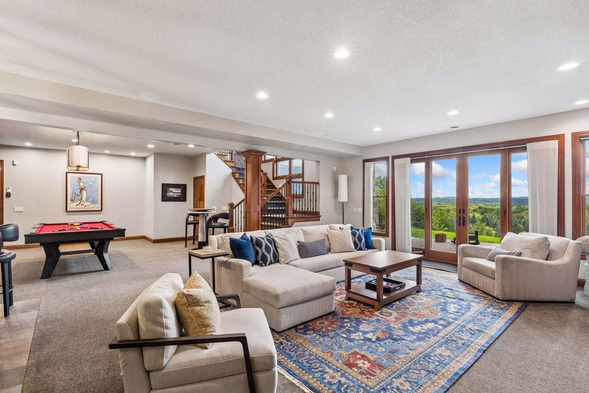 Open lower level with wet bar, lounge area and walkout views of the St. Croix Valley