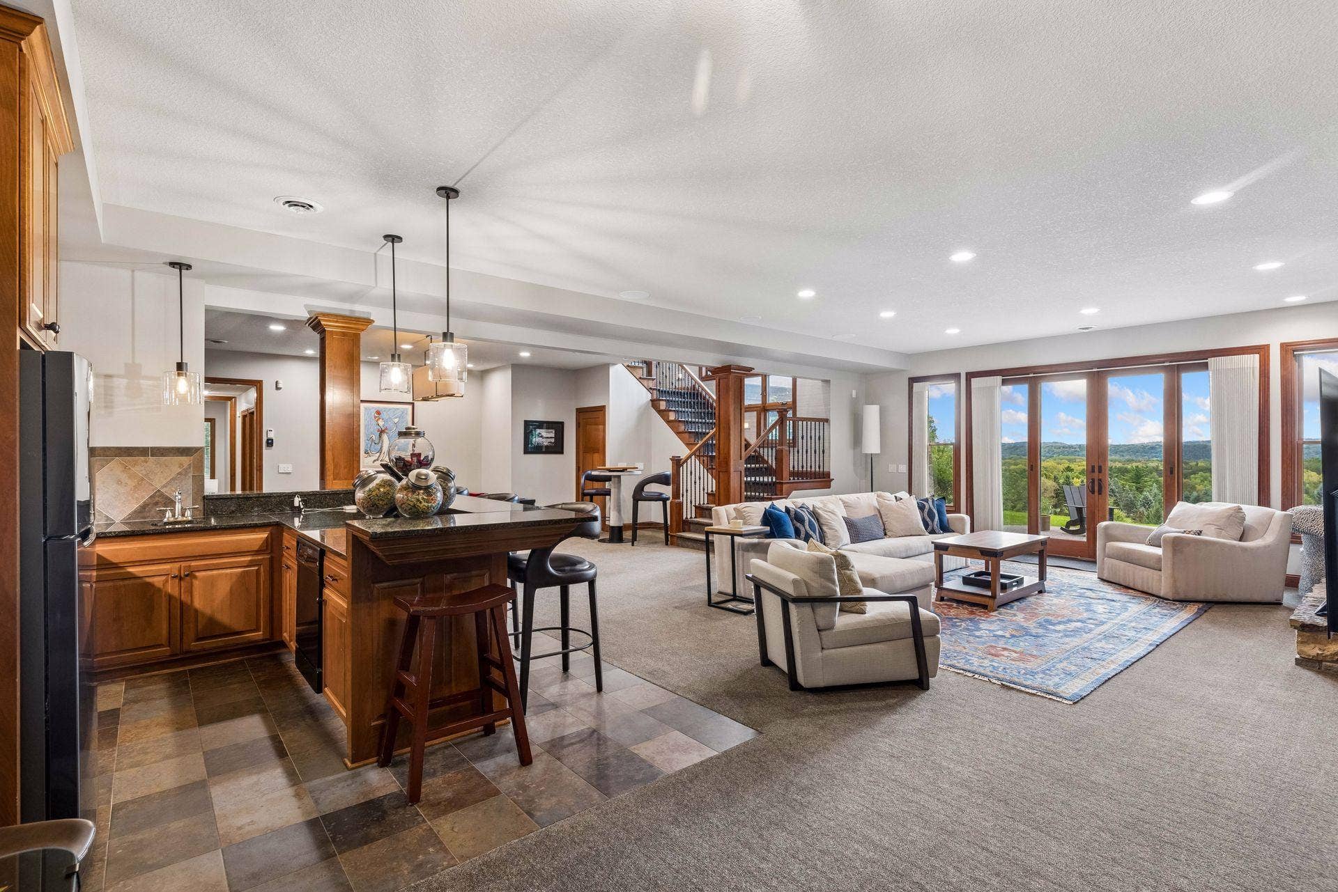 Open lower level with wet bar, lounge area and walkout views of the St. Croix Valley