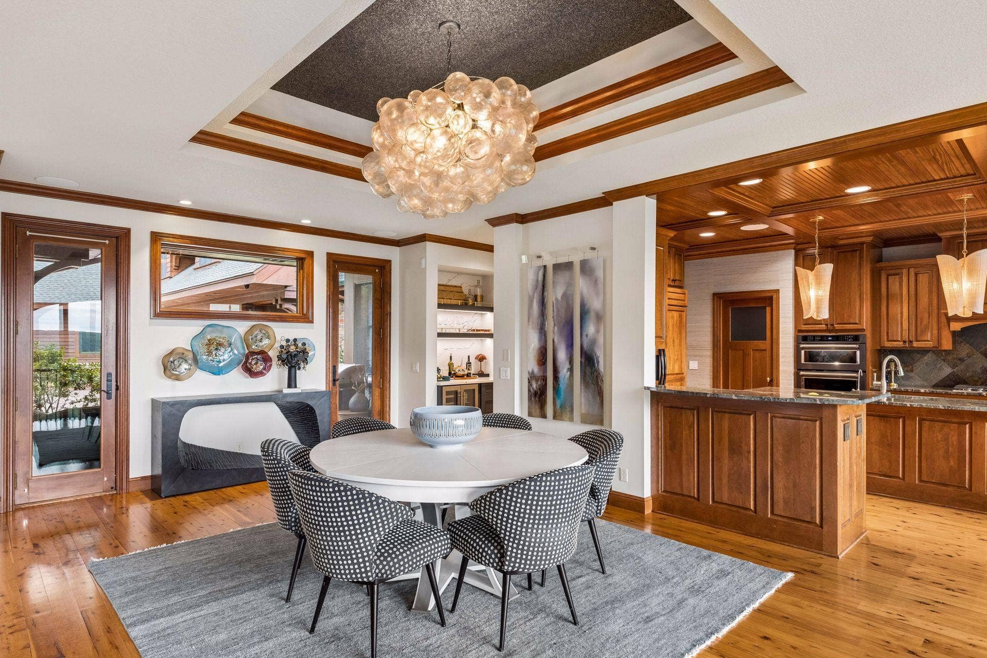 A custom tray ceiling, designer chandelier, and built-in bar set the stage for elegant dining, with St. Croix views just beyond