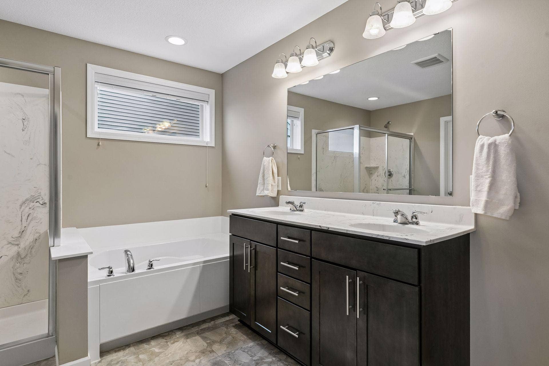 9135 Lighthouse Lane, Woodbury, MN 55129 Primary bath with double sink vanity and separate tub and shower