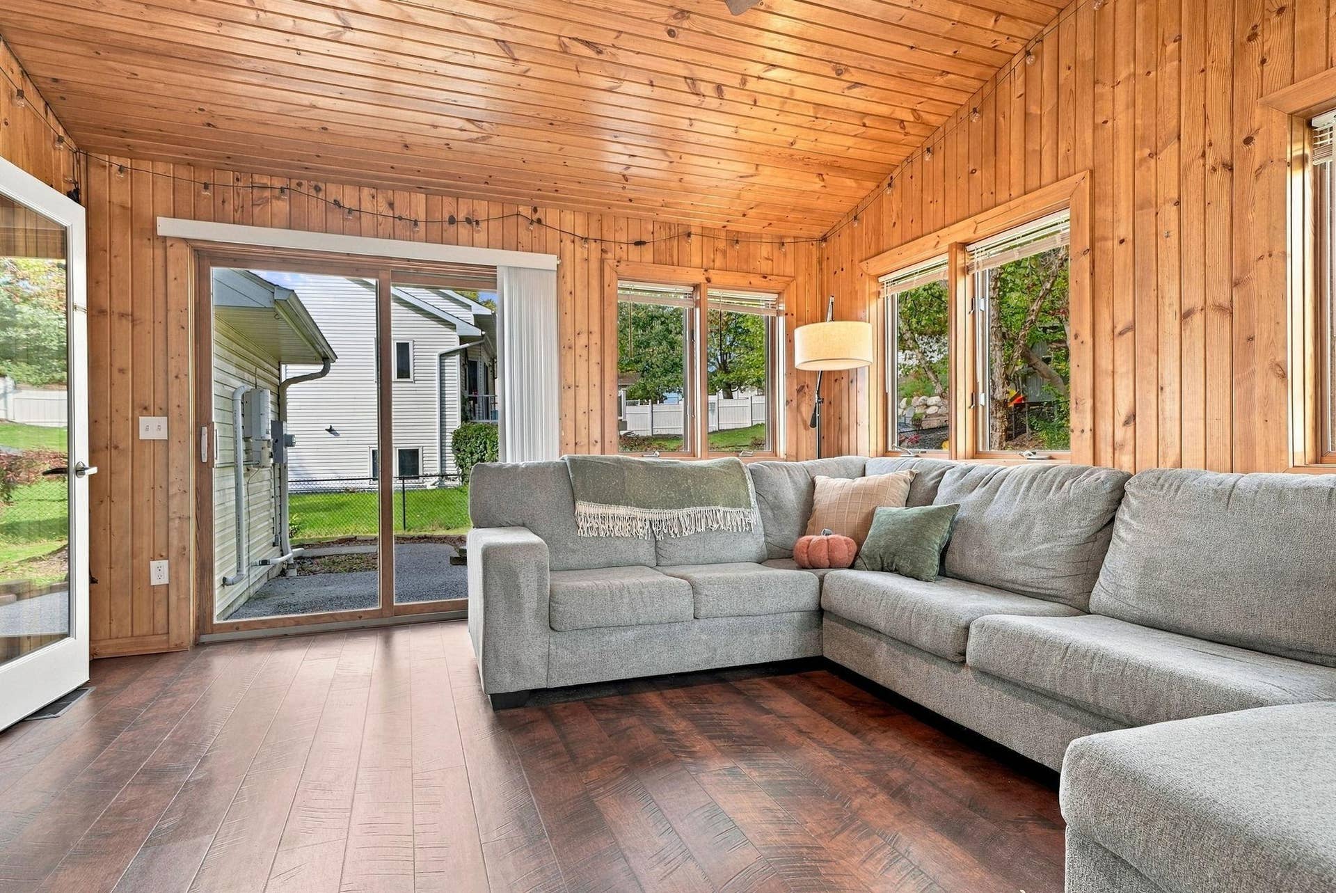 The sliding glass door in the porch leads to the backyard.