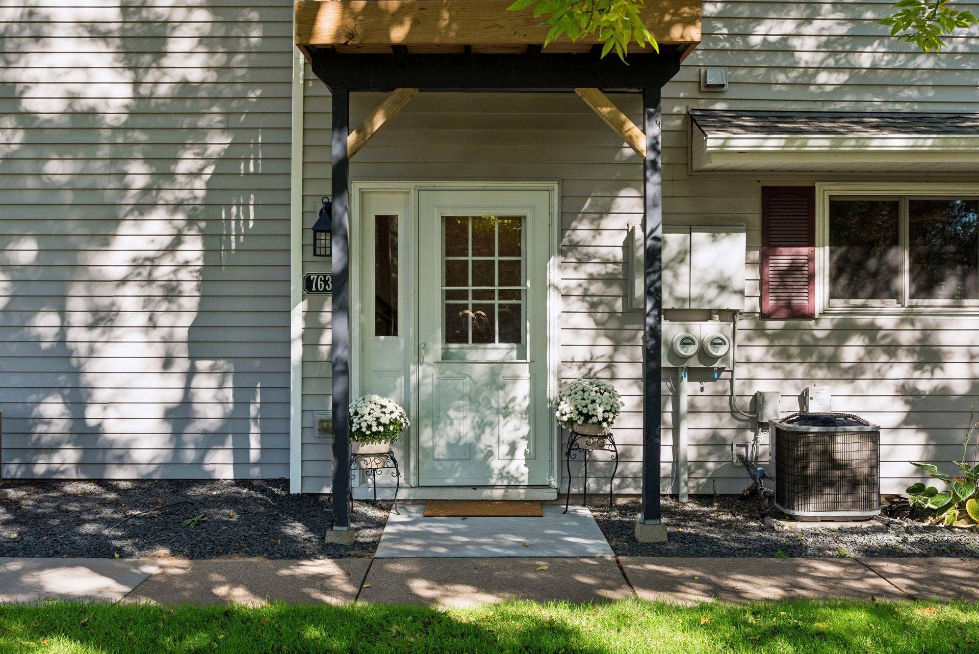 7638 13th Street N, Oakdale, MN 55128 Your own private entrance welcomes you home, with a full flight of stairs inside leading to the main living spaces above.