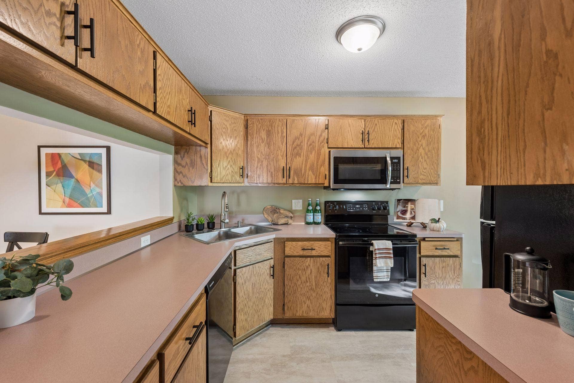 7638 13th Street N, Oakdale, MN 55128 Plenty of cabinet and counter space makes meal prep easy, with a pass-through to the dining area, new flooring, a brand-new microwave and a stove, refrigerator and dishwasher replaced around 2019.