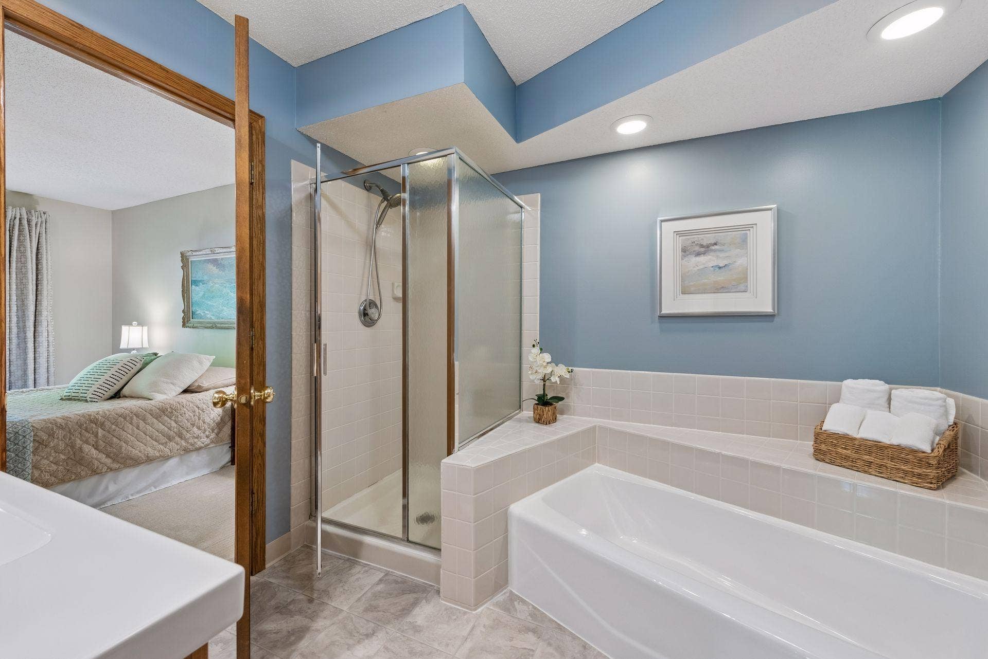 7638 13th Street N, Oakdale, MN 55128 Enjoy direct access from the primary bedroom to the spacious bathroom, featuring a separate shower and a tub for unwinding at the end of the day.