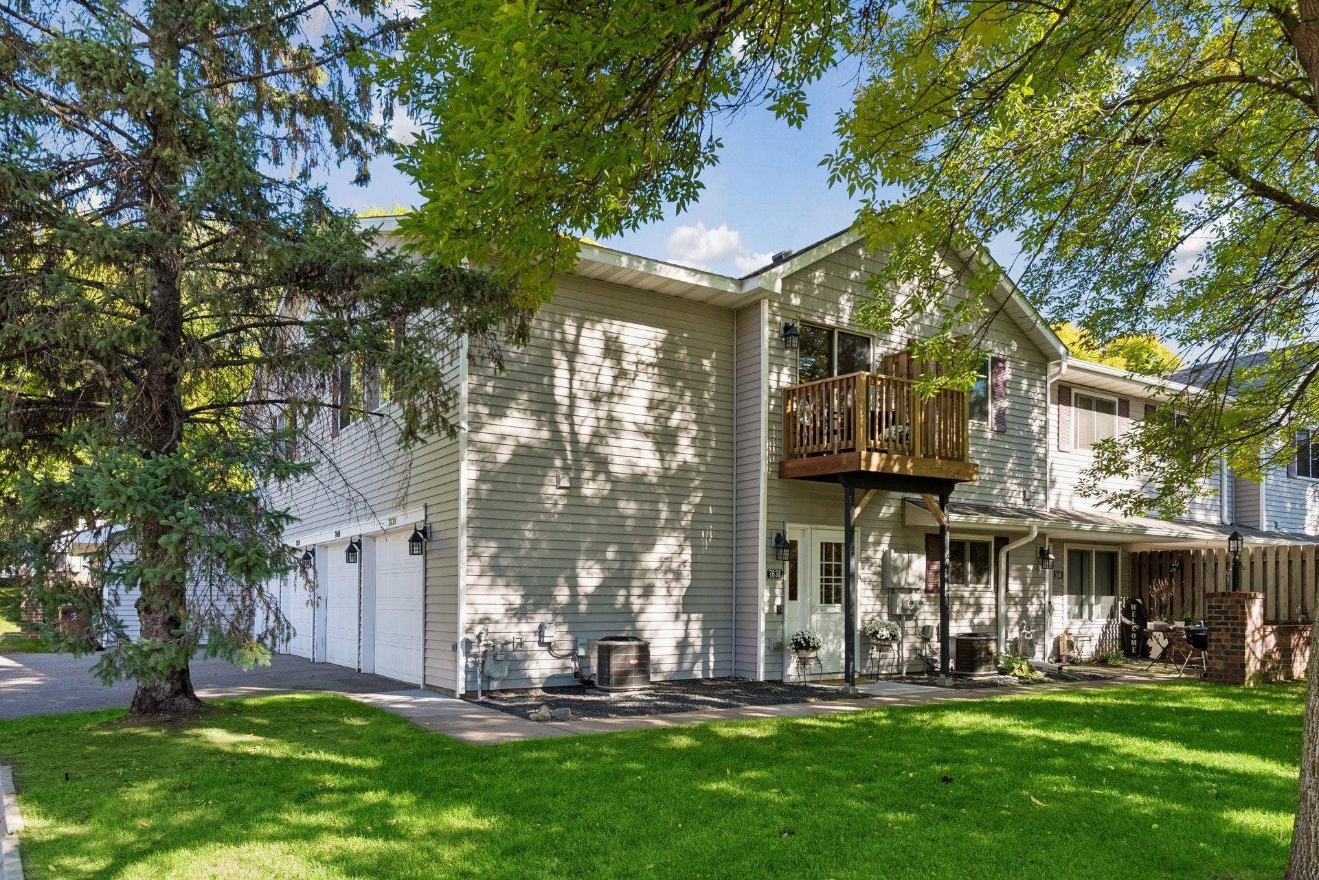 7638 13th Street N, Oakdale, MN 55128 Mature trees frame this corner home, with its own private entrance and a brand-new deck abovea welcoming place to come home to.