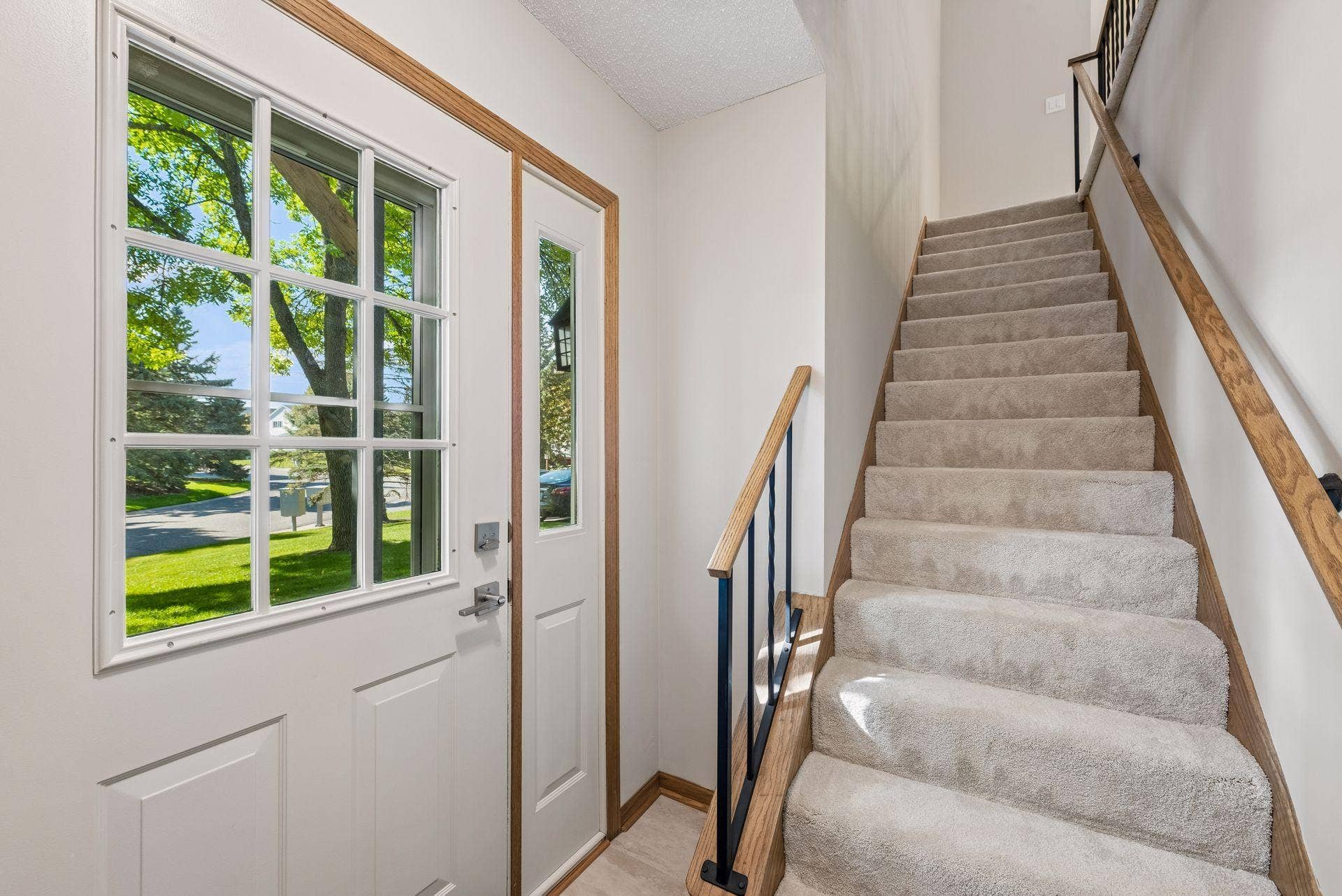 7638 13th Street N, Oakdale, MN 55128 A bright entry and newly carpeted staircase lead up a full flight to the living room, kitchen, both bedrooms and bathroomall together on the upper level.