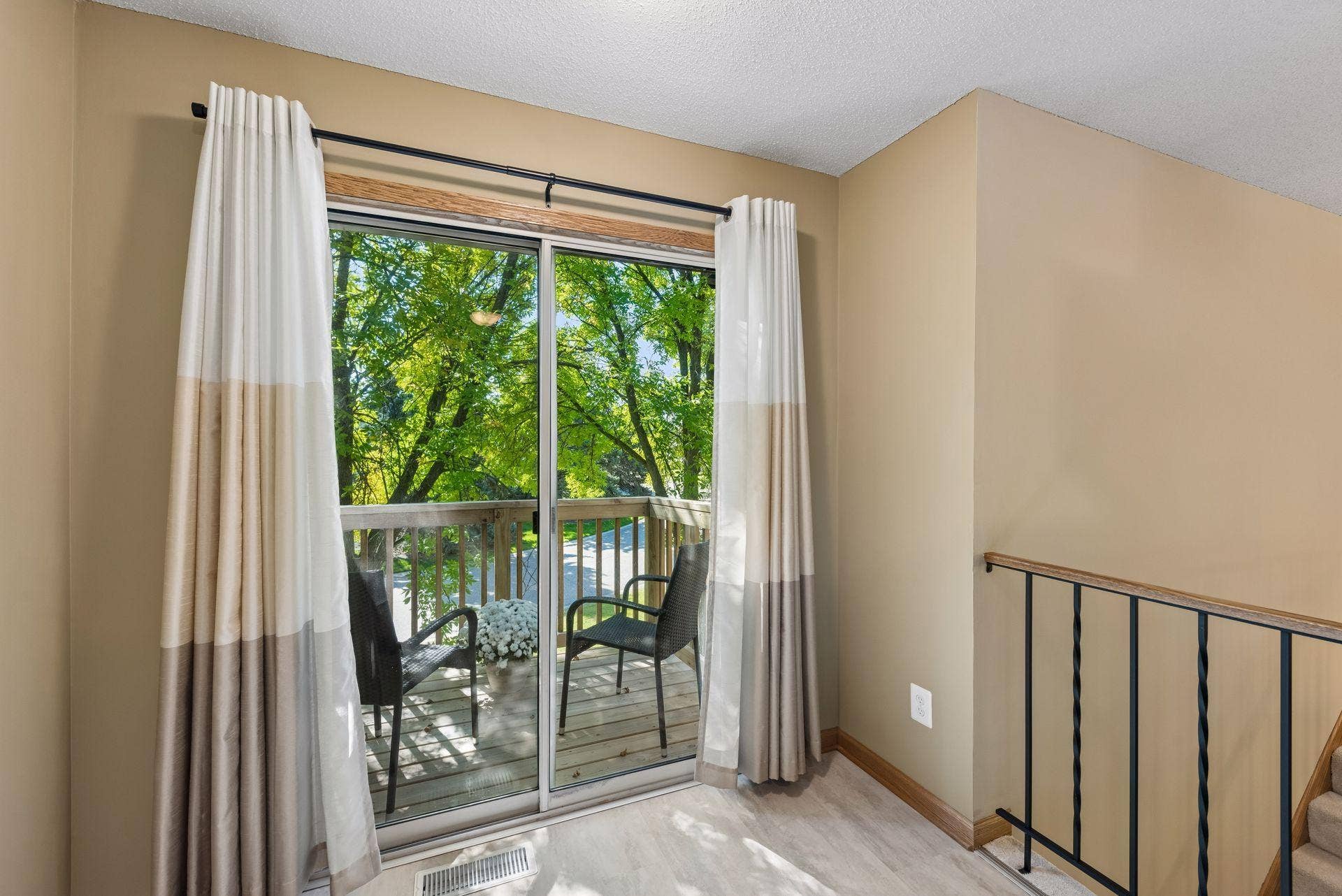 7638 13th Street N, Oakdale, MN 55128 Step outside for a breath of fresh air or a quiet reading breakthe brand-new deck offers a cozy retreat tucked among mature branches.