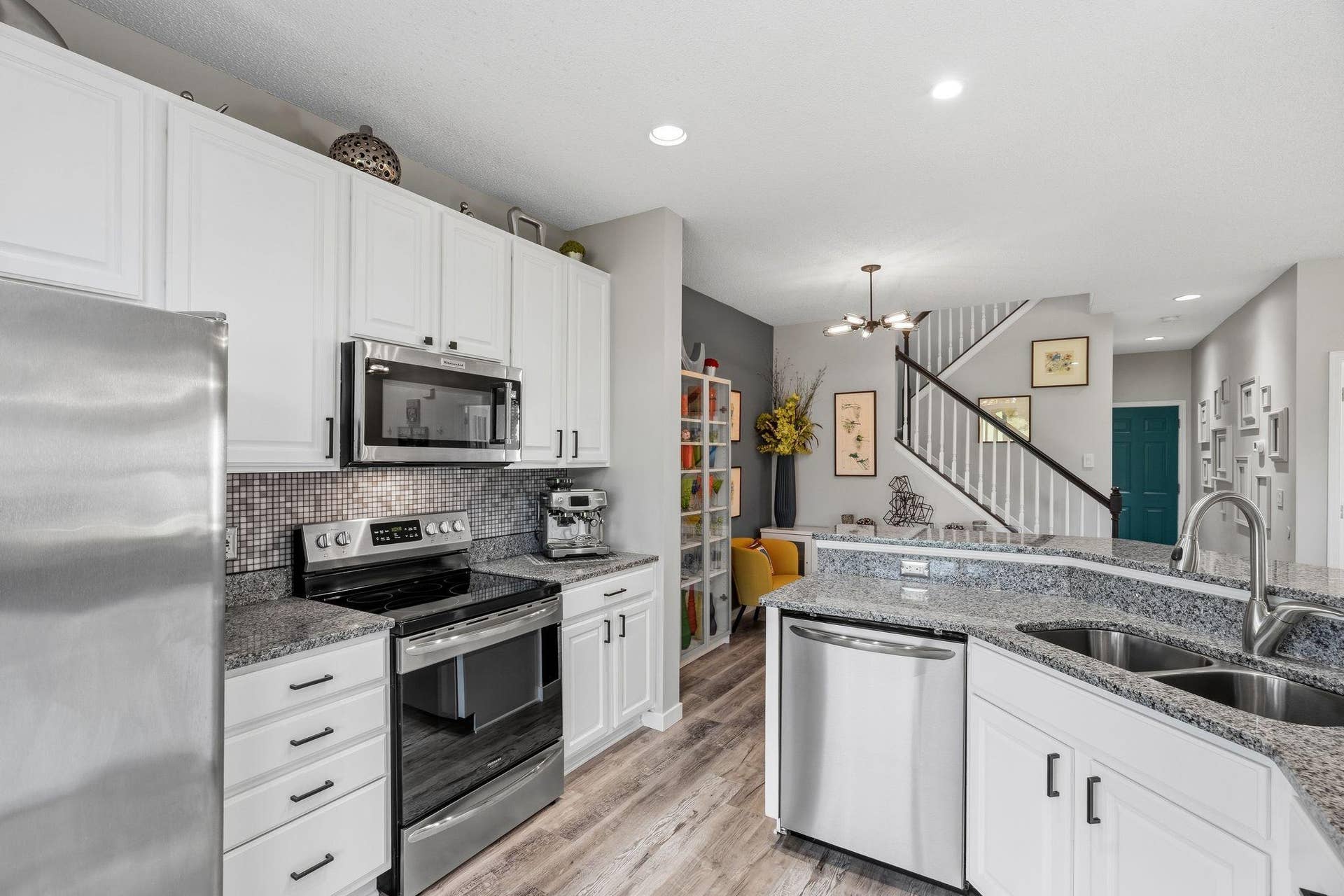 8967 Comstock Lane N, Maple Grove, MN 55311 Kitchen has a continuation of the flooring plus stainless appliances.