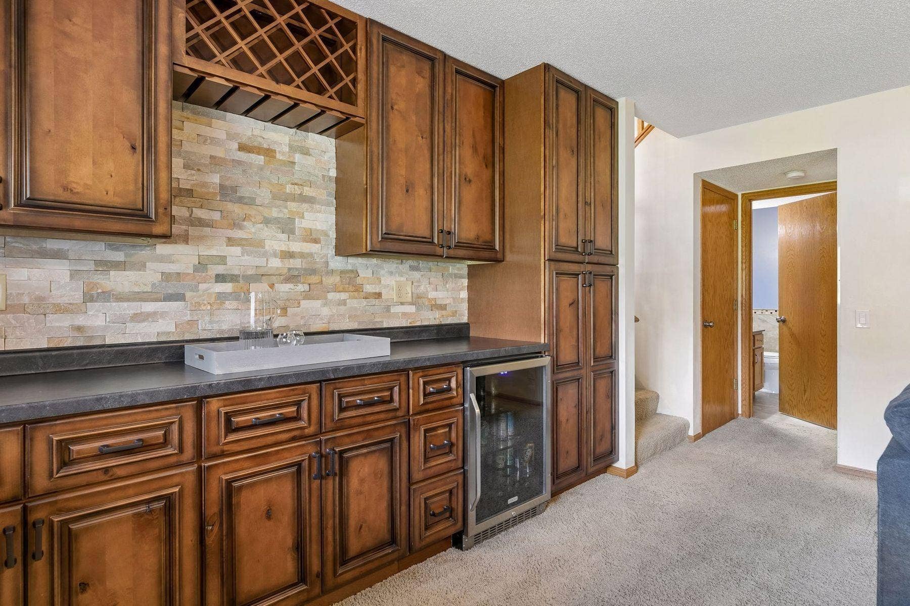 1049 Bonnieview Drive, Woodbury, MN 55129 Convenient dry bar with ample storage for hosting