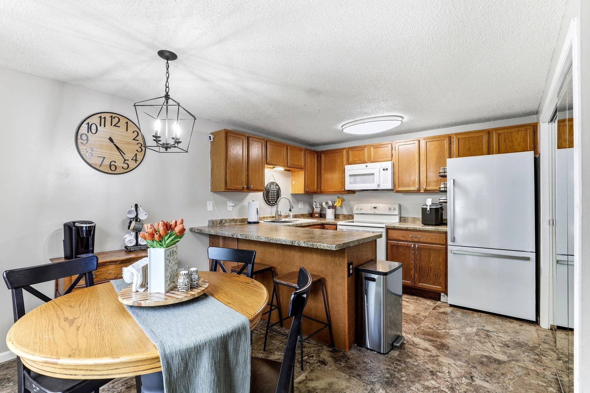 Functional Kitchen and Dining layout with a large peninsula providing extra prep space and casual seating.