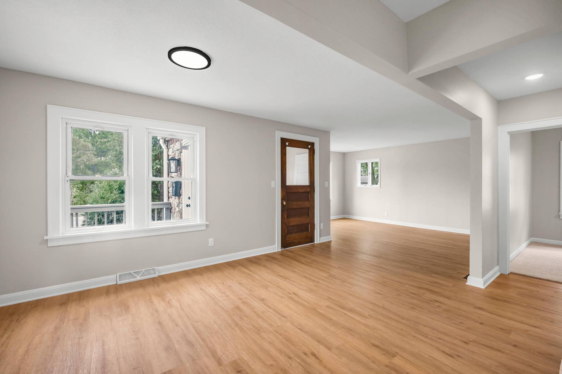 756 Mcknight Road N, Maplewood, MN 55119 A ton of natural light streaming through the windows (many are vinyl) and beautiful wooden door separating the entry space from the living room.