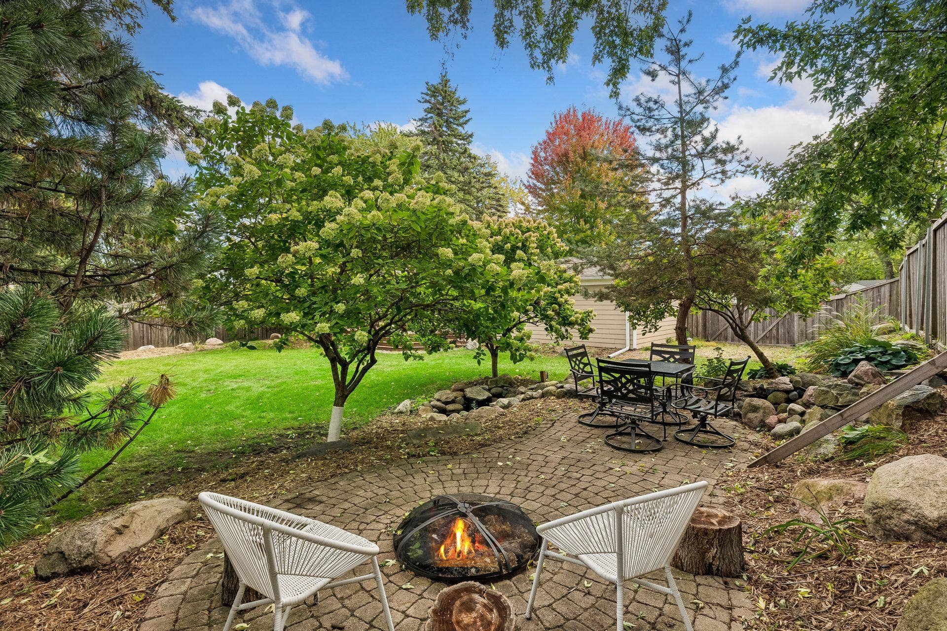 Private back yard patio with fire pit and fountain