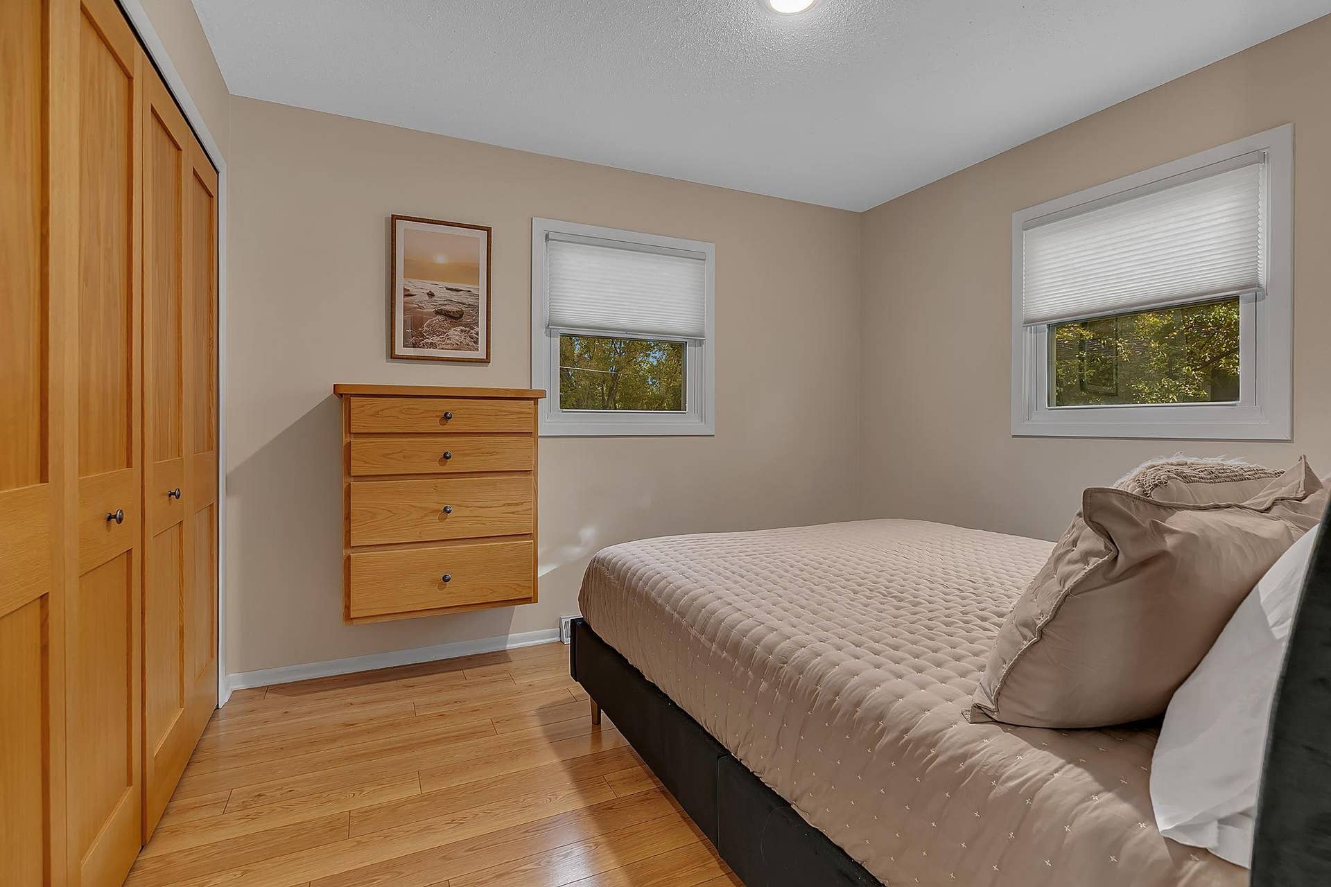 Second bedroom on the main with built-in dresser and closet organizers.