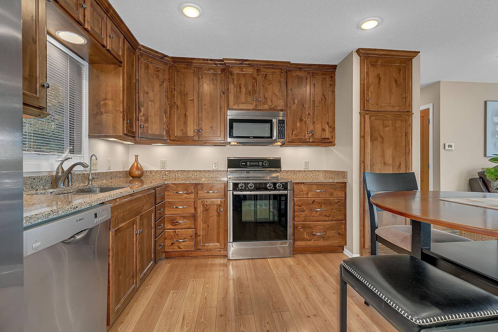 Knotty alder custom cabinets, stainless steel appliances and granite countertops - move-in ready!