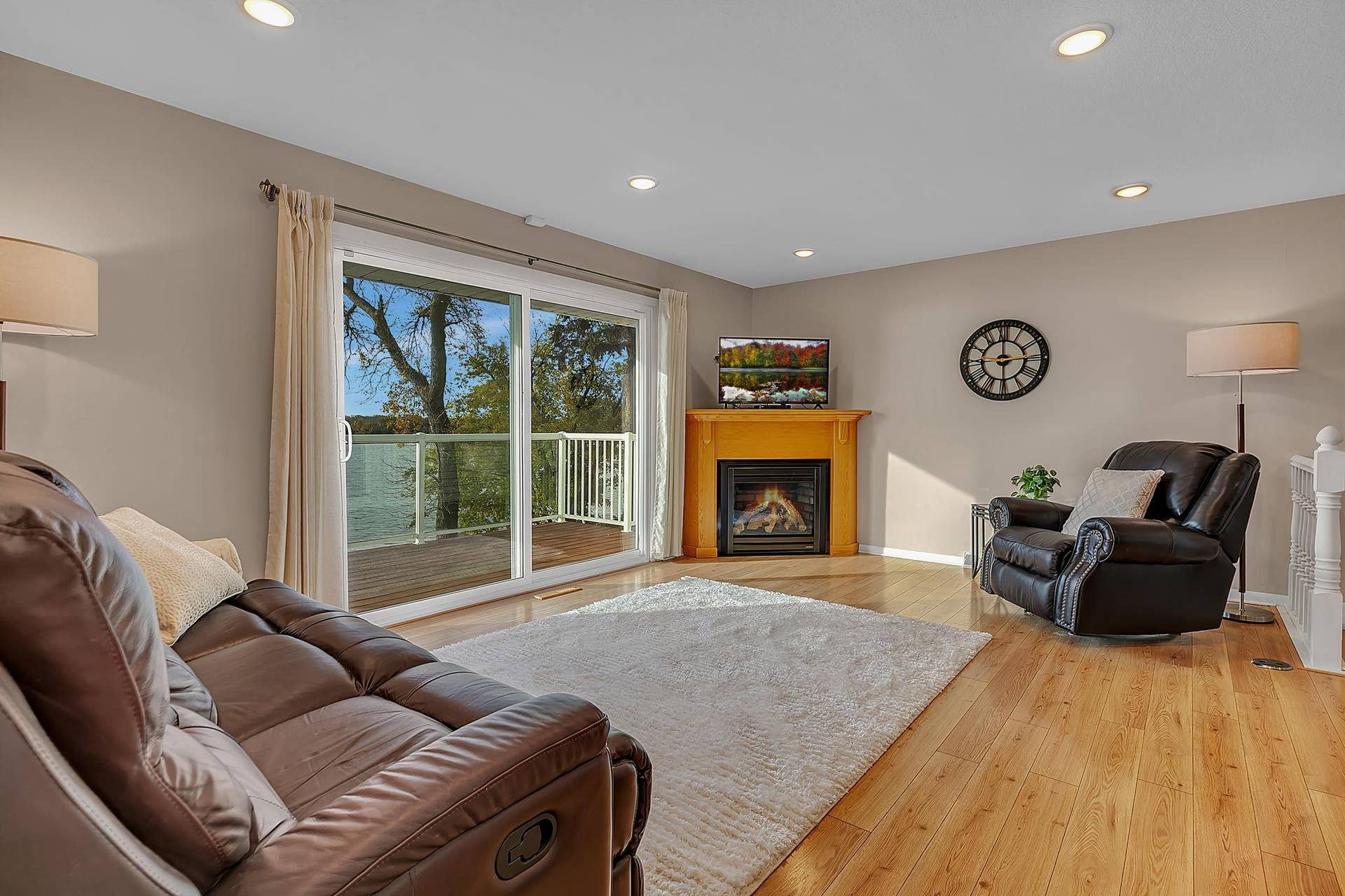 Open layout, gas fireplace and oversized sliding patio door for easy access to the maintenance free deck