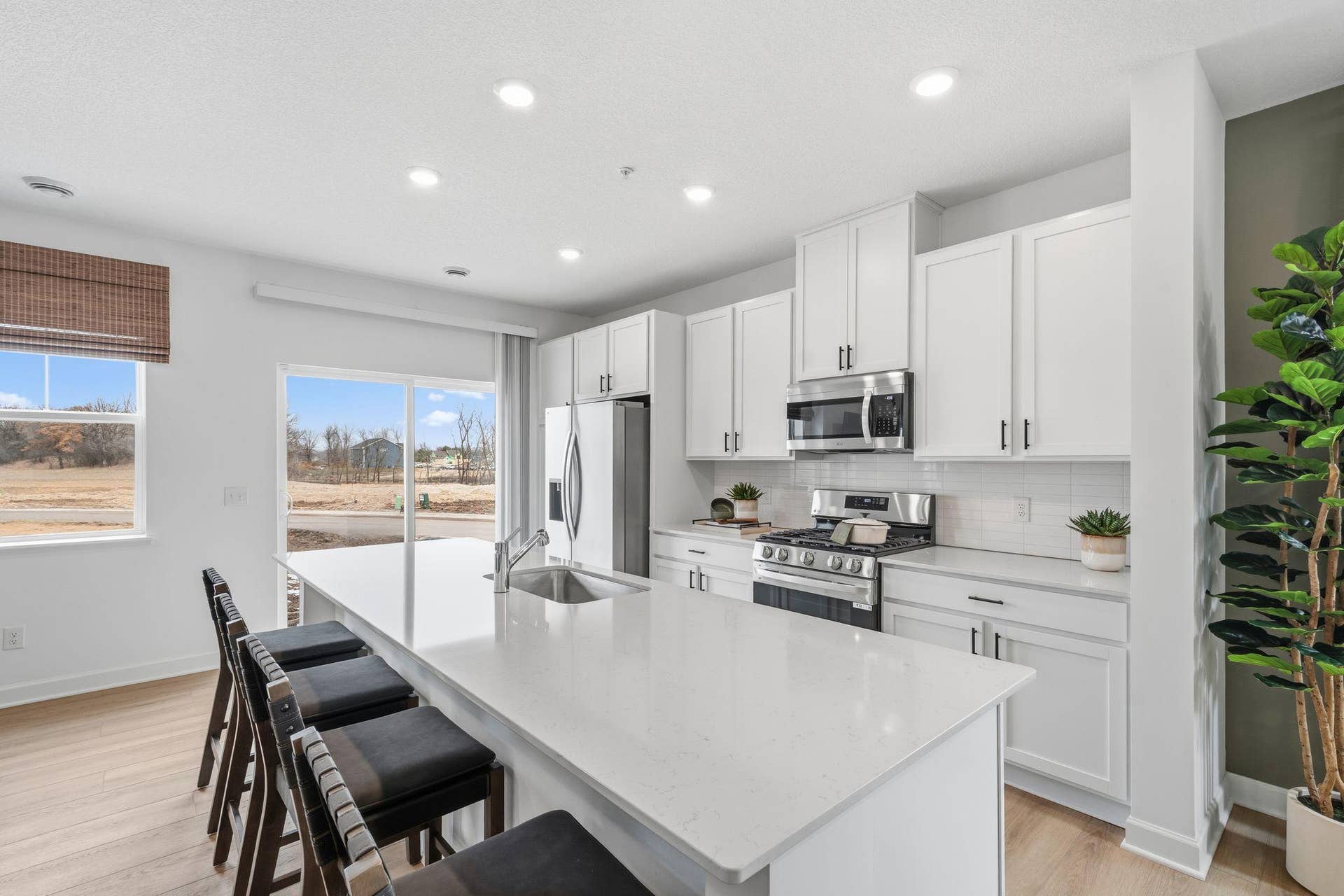 4004 Hayward Avenue N, Oakdale, MN 55128 (All photos are of the actual model home.) At the focal point of this modern kitchen is a quartz-topped center island to add bar-style seating, complemented by extensive cabinetry room and all-new stainless steel appliances to craft delicious meals.