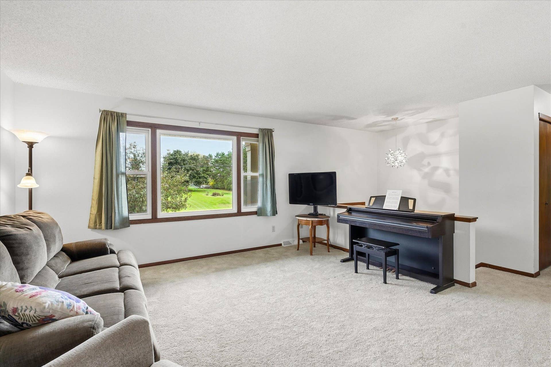 20761 187th Avenue NW, Big Lake, MN 55309 Spacious living room featuring new carpet, neutral finishes, and a large picture window bringing in plenty of natural light.