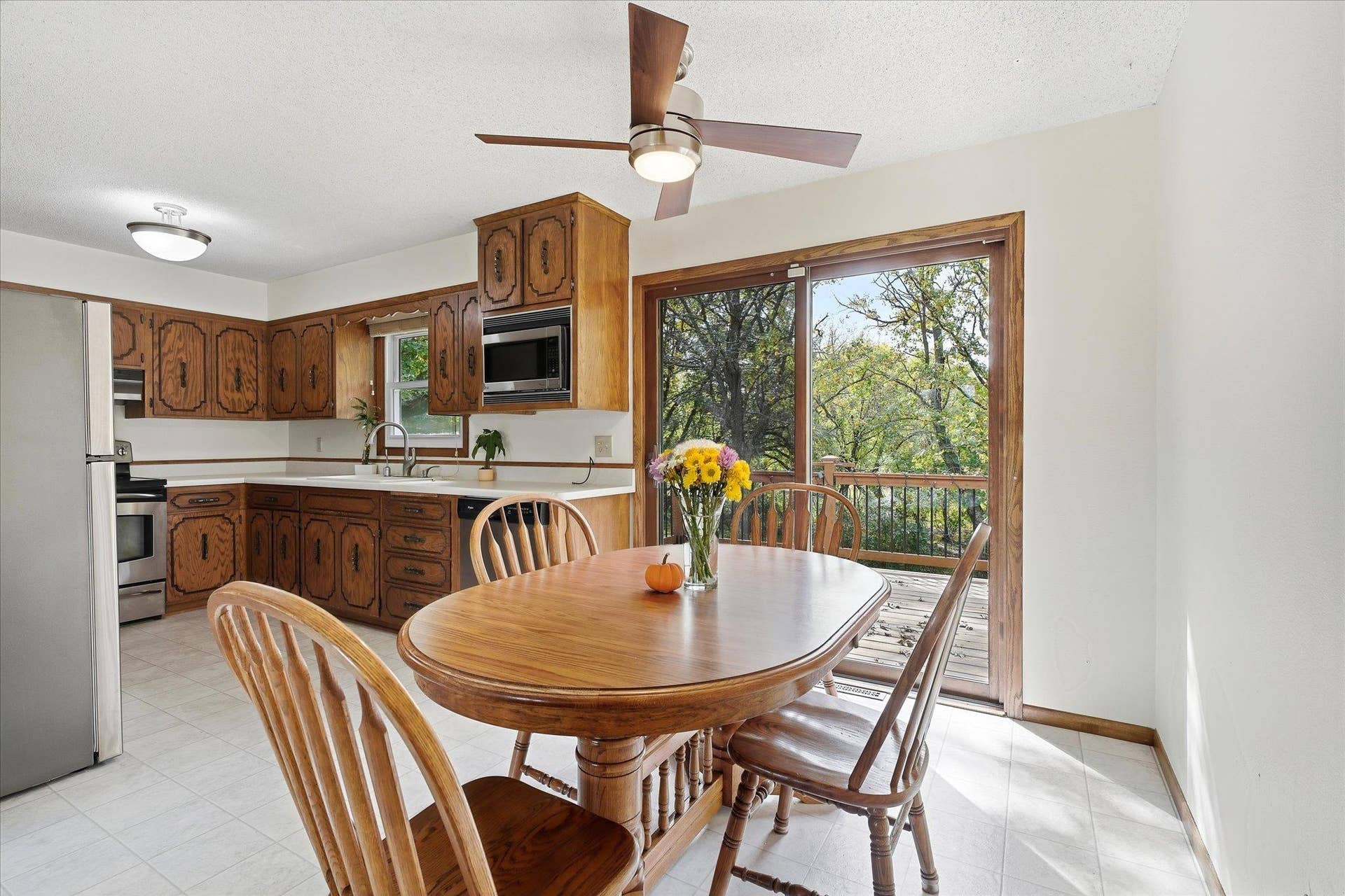 20761 187th Avenue NW, Big Lake, MN 55309 Informal dining area conveniently located off the kitchen, featuring a ceiling fan and sliding glass door to the deck, where you can enjoy peaceful nature views while dining.