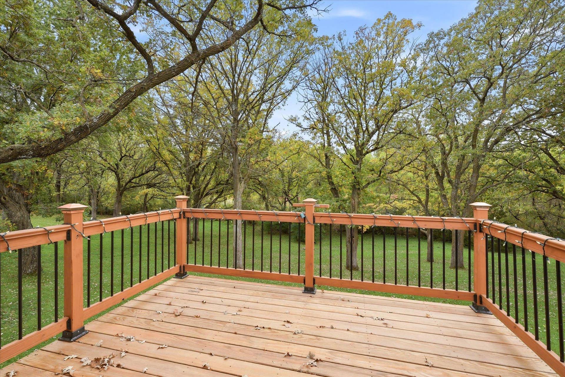20761 187th Avenue NW, Big Lake, MN 55309 Spacious deck overlooking the beautiful, tree-filled backyard, offering plenty of room for grilling, outdoor dining, entertaining, and relaxing while enjoying the peaceful natural surroundings.