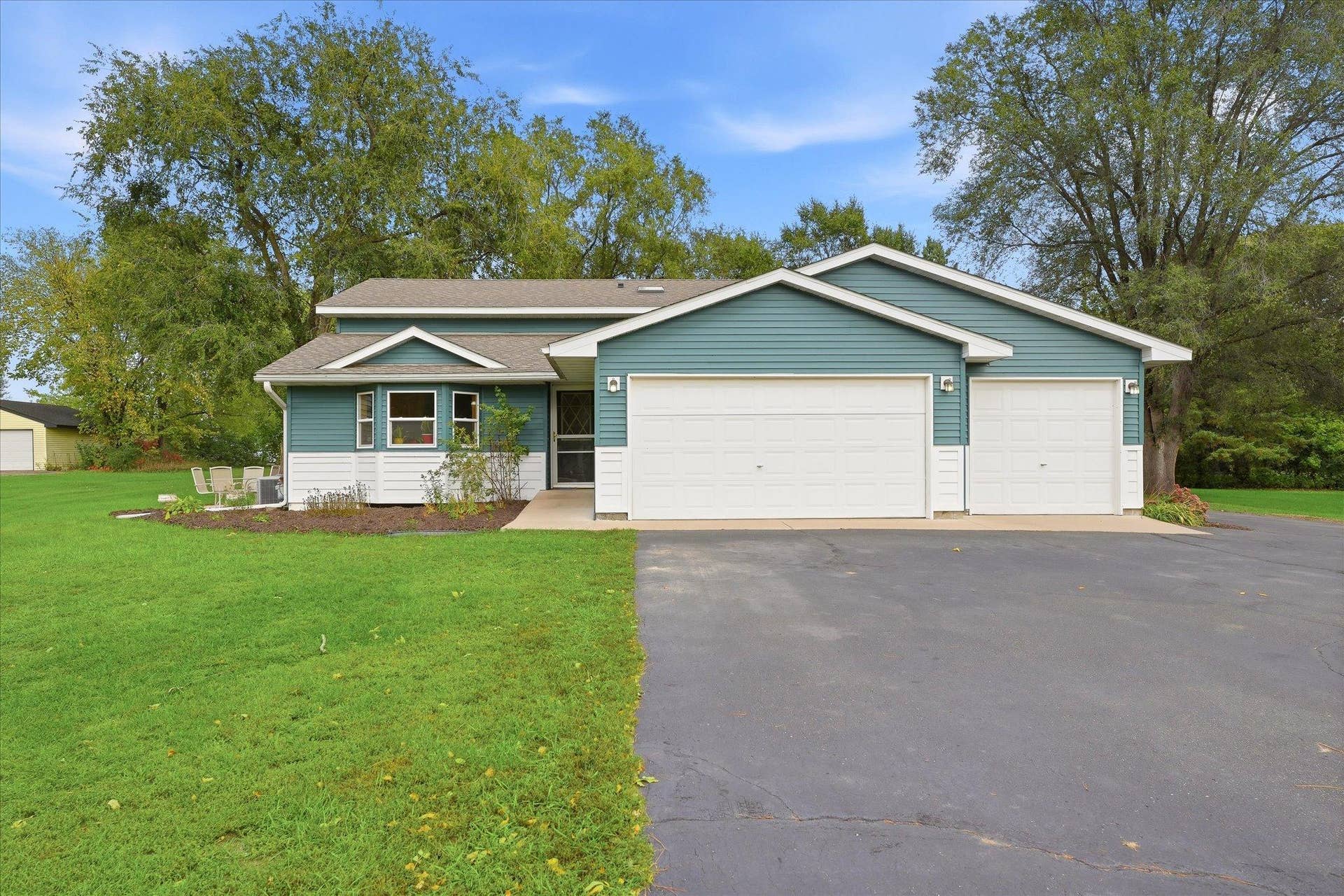 20720 187th Avenue NW, Big Lake, MN 55309 Attractive front exterior with low-maintenance vinyl siding, established landscaping, and an oversized driveway providing plenty of parking.