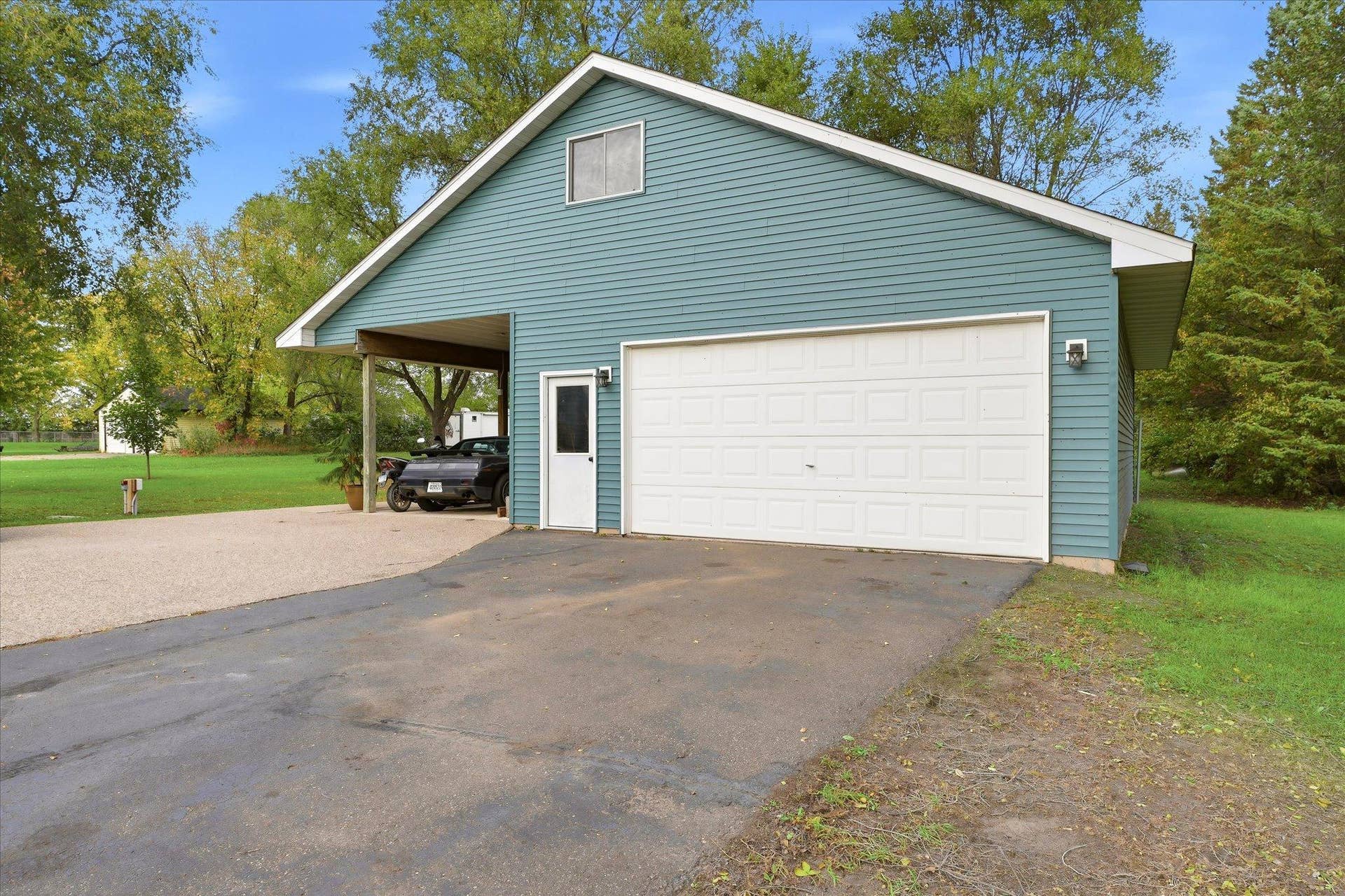 20720 187th Avenue NW, Big Lake, MN 55309 A standout feature of this property is the second detached, heated two-car garage, complete with a covered carport and pull-down attic access.