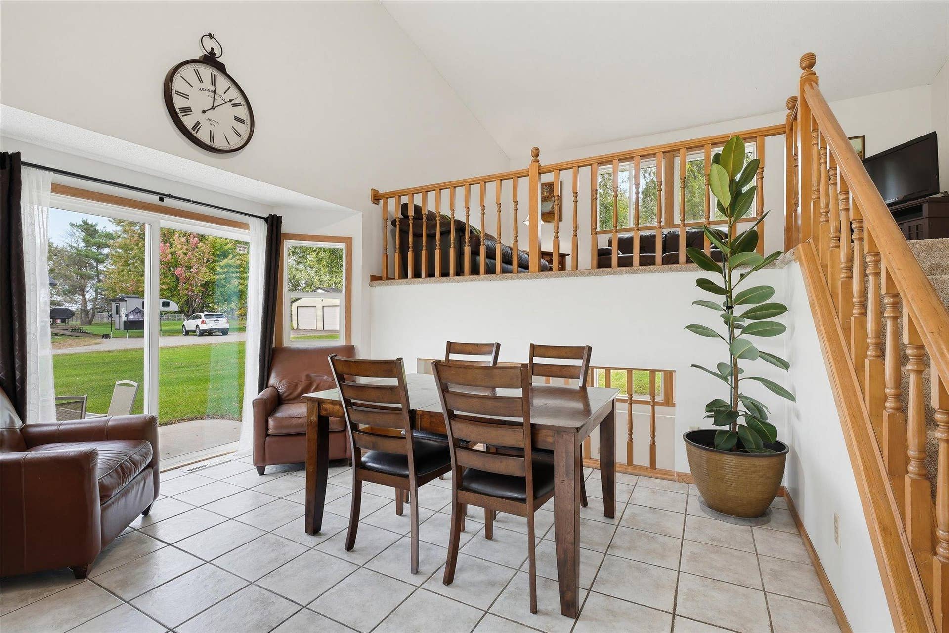 20720 187th Avenue NW, Big Lake, MN 55309 Bright dining area features a vaulted ceiling, tile flooring, and sliding glass doors providing direct access to the side patio.