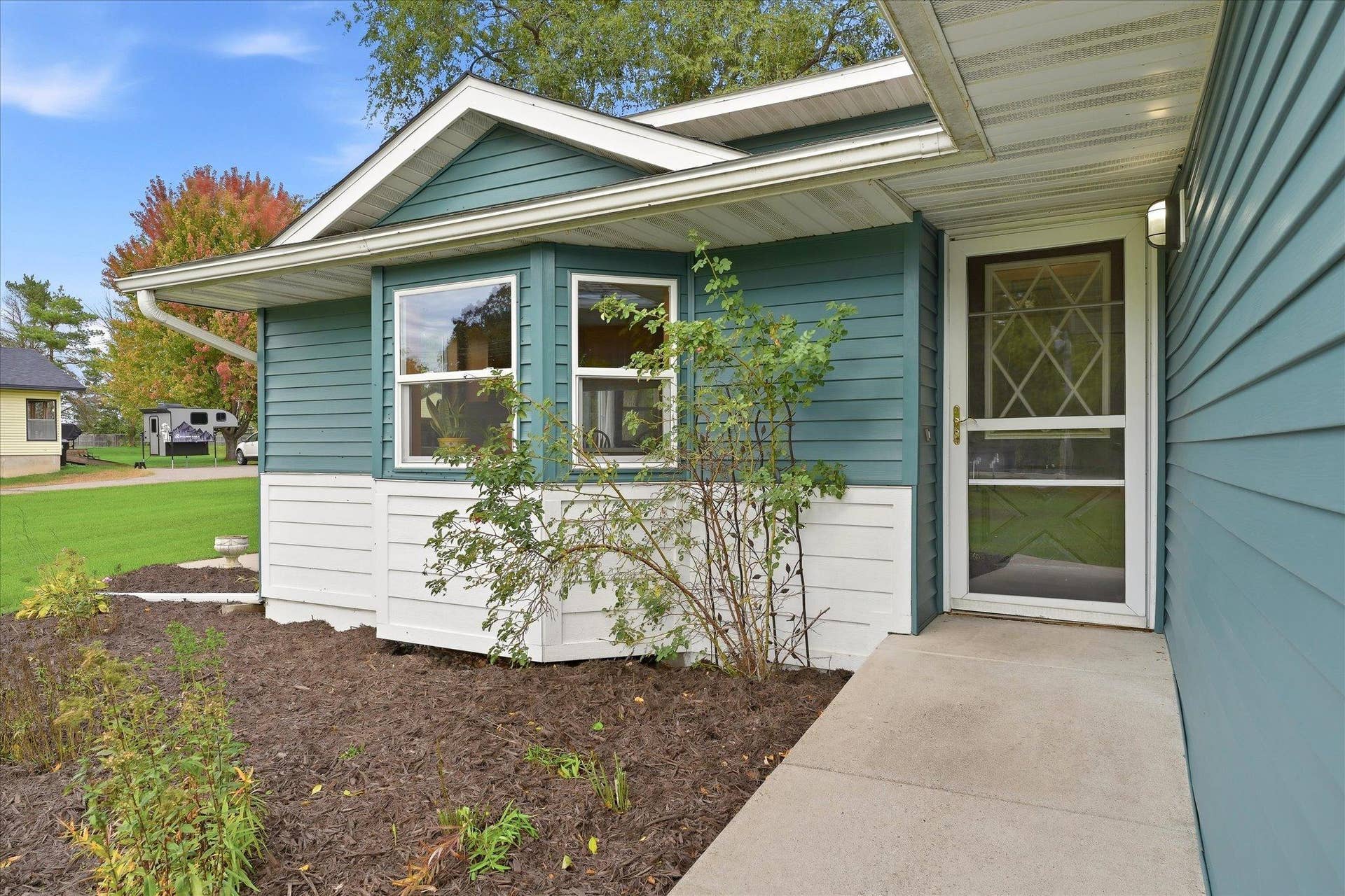 20720 187th Avenue NW, Big Lake, MN 55309 Covered front entry surrounded by landscaping creates a welcoming approach to the home.