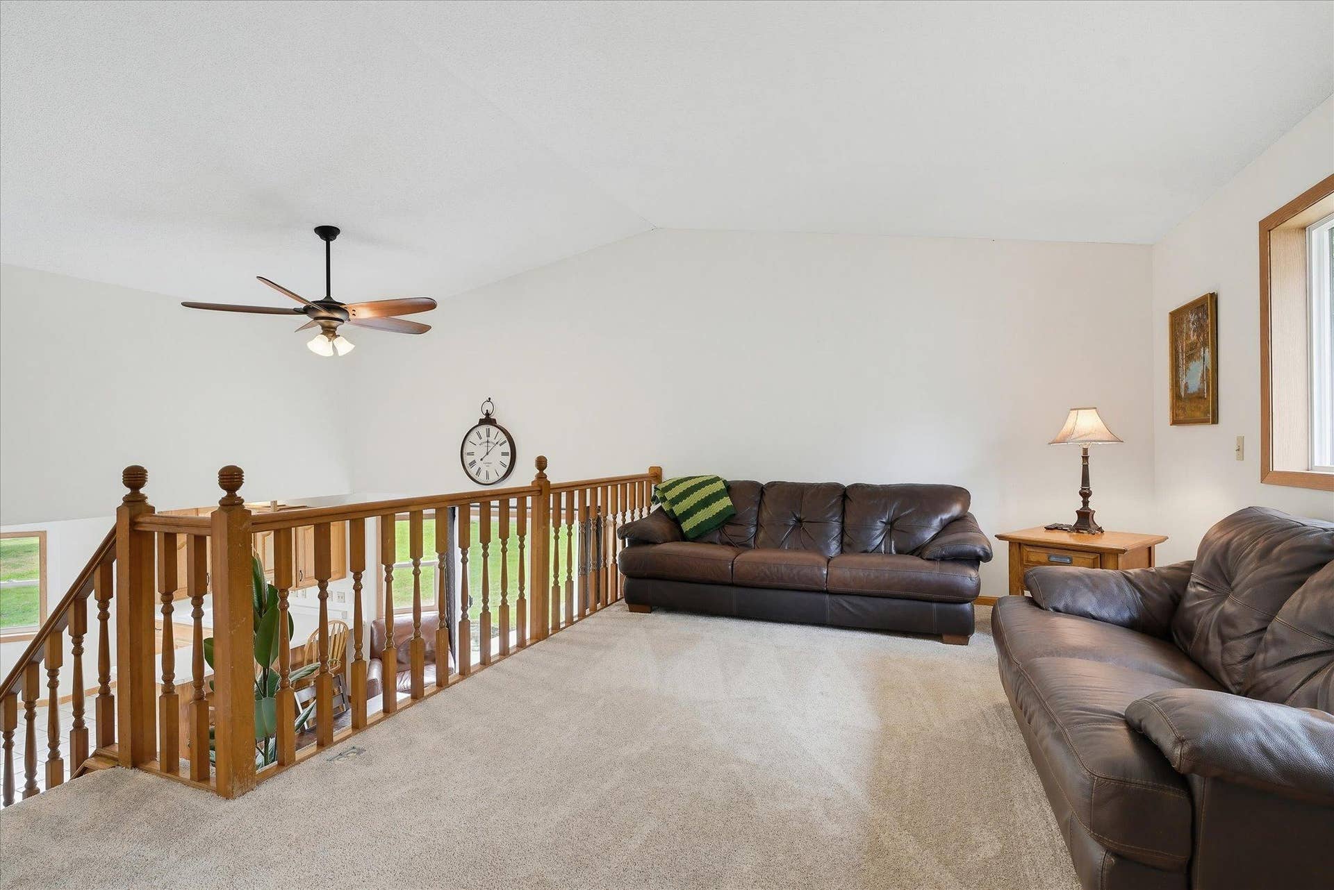 20720 187th Avenue NW, Big Lake, MN 55309 Spacious upper-level living room features new carpet, a vaulted ceiling and overlooks the dining area below, adding to the homes open, multi-level design.