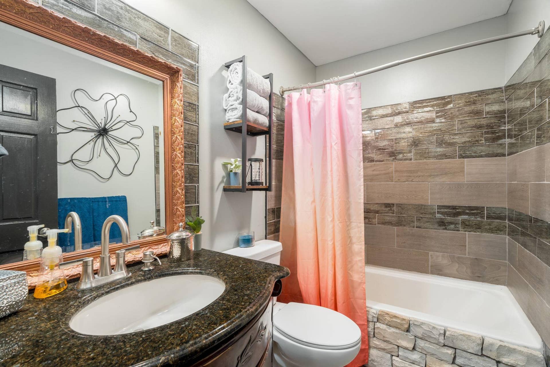 465 70th Avenue, Clayton, WI 54004 Updated bathroom featuring a granite vanity, decorative tile surround and tub/shower combination.