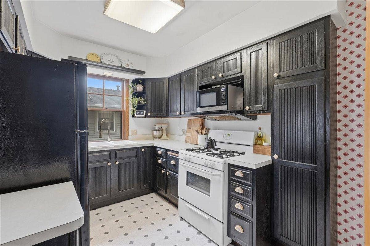 Everything you need within easy reach. The kitchen makes smart use of its footprint with abundant cabinetry and workspace for everyday cooking.