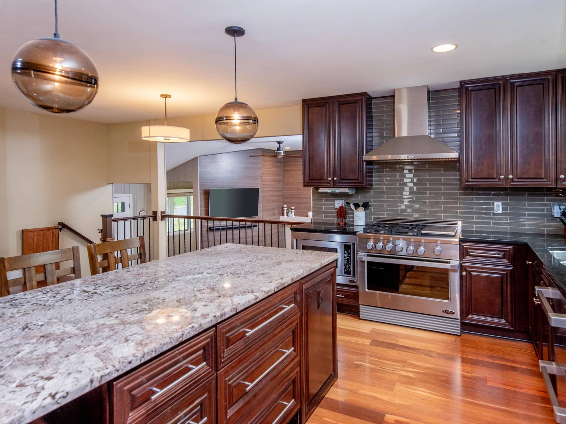 1492 Red Cedar Road, Eagan, MN 55121 Thoughtfully updated, this kitchen boasts custom cherry cabinetry, high-end appliances, granite countertops and a beautiful tile backsplash.