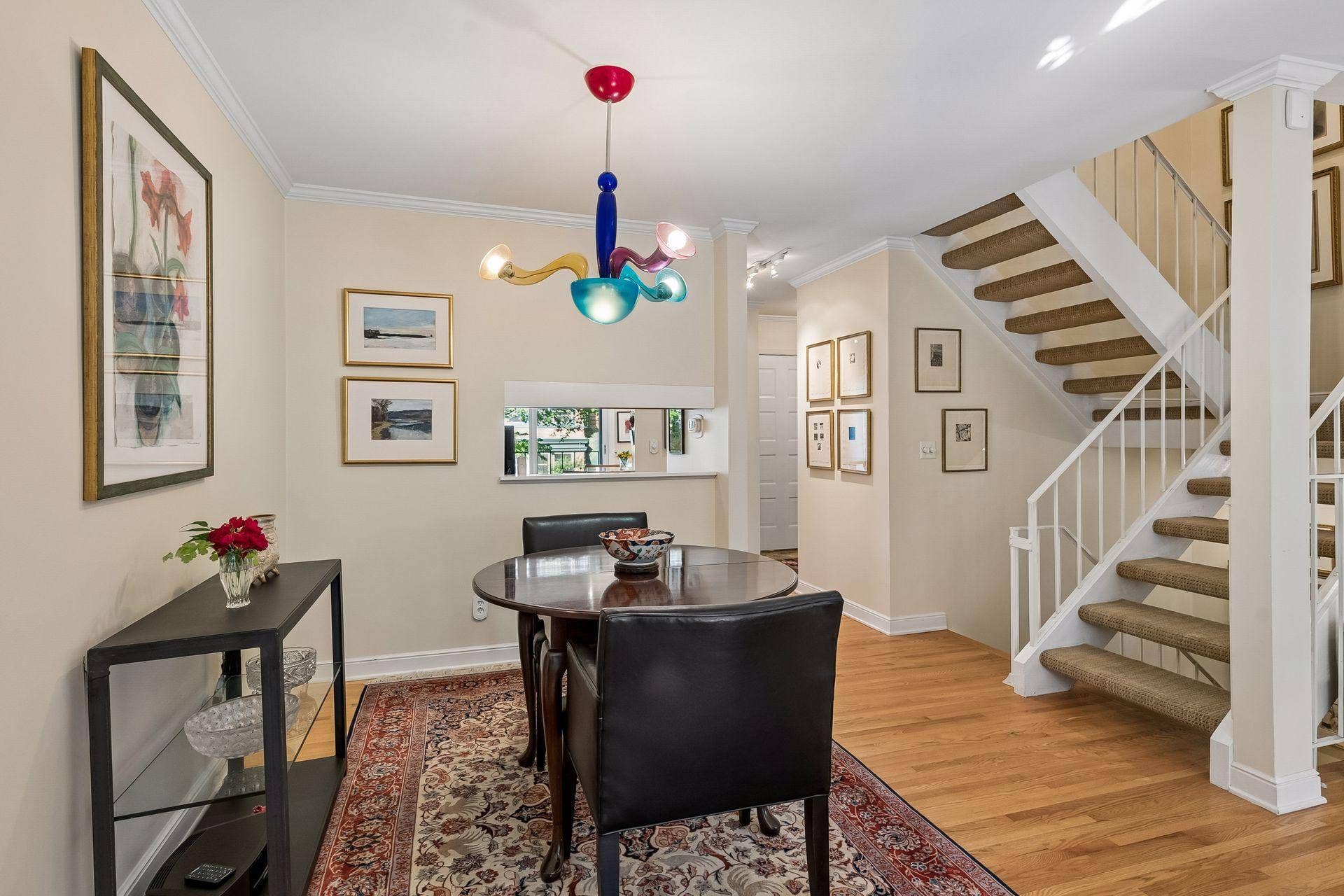 Views to the pass through window, kitchen, and foyer - this dining room can host small or large dinner parties