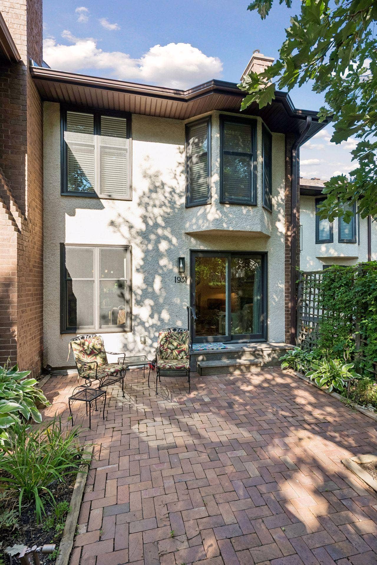 The paver patio adds charm to this backyard space. Great for outdoor entertaining and grilling. Amazing views of the courtyard/commons area. Lush greenery surrounds you!