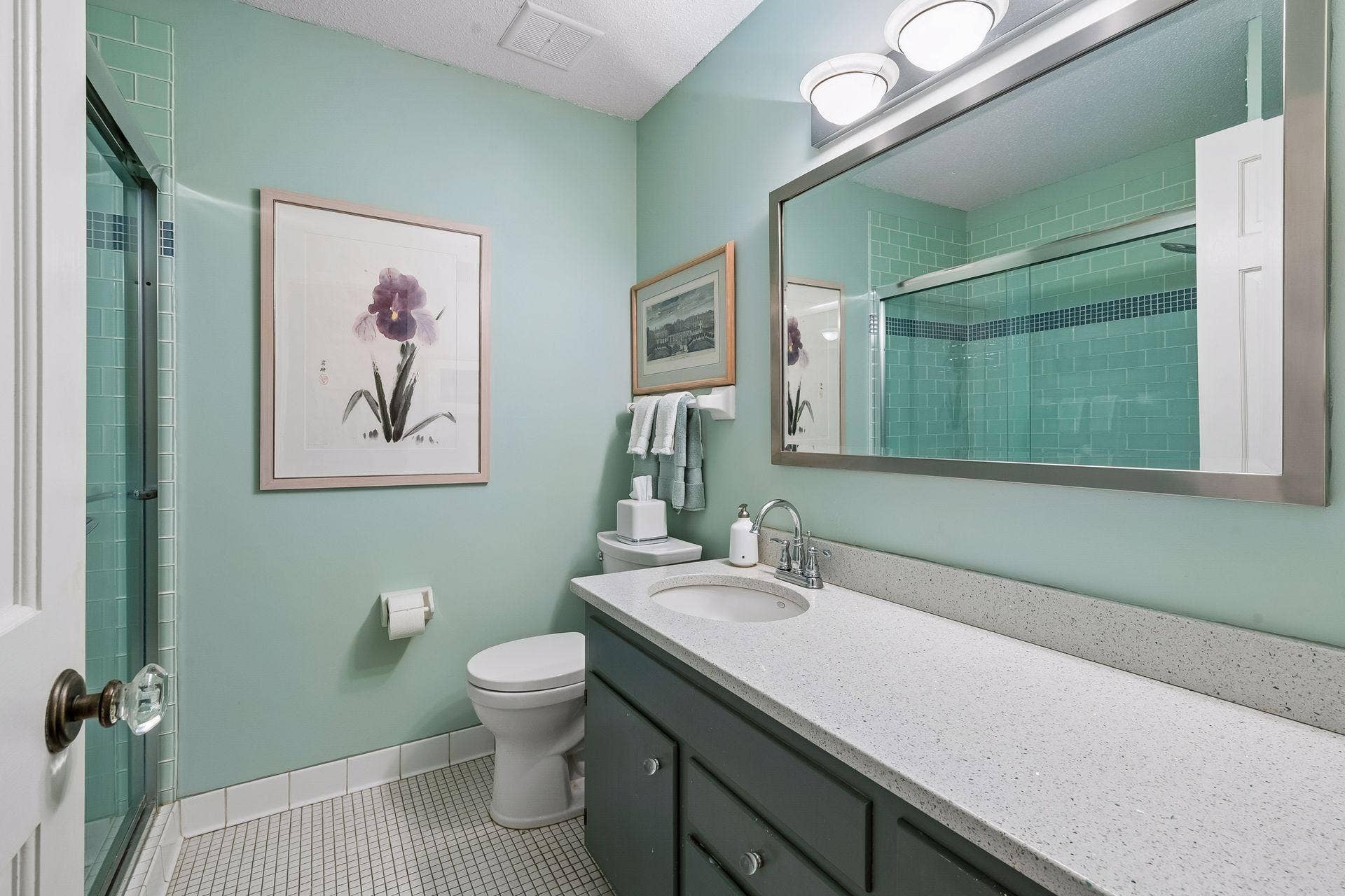 Oversized vanity with quartz countertop and walk in shower