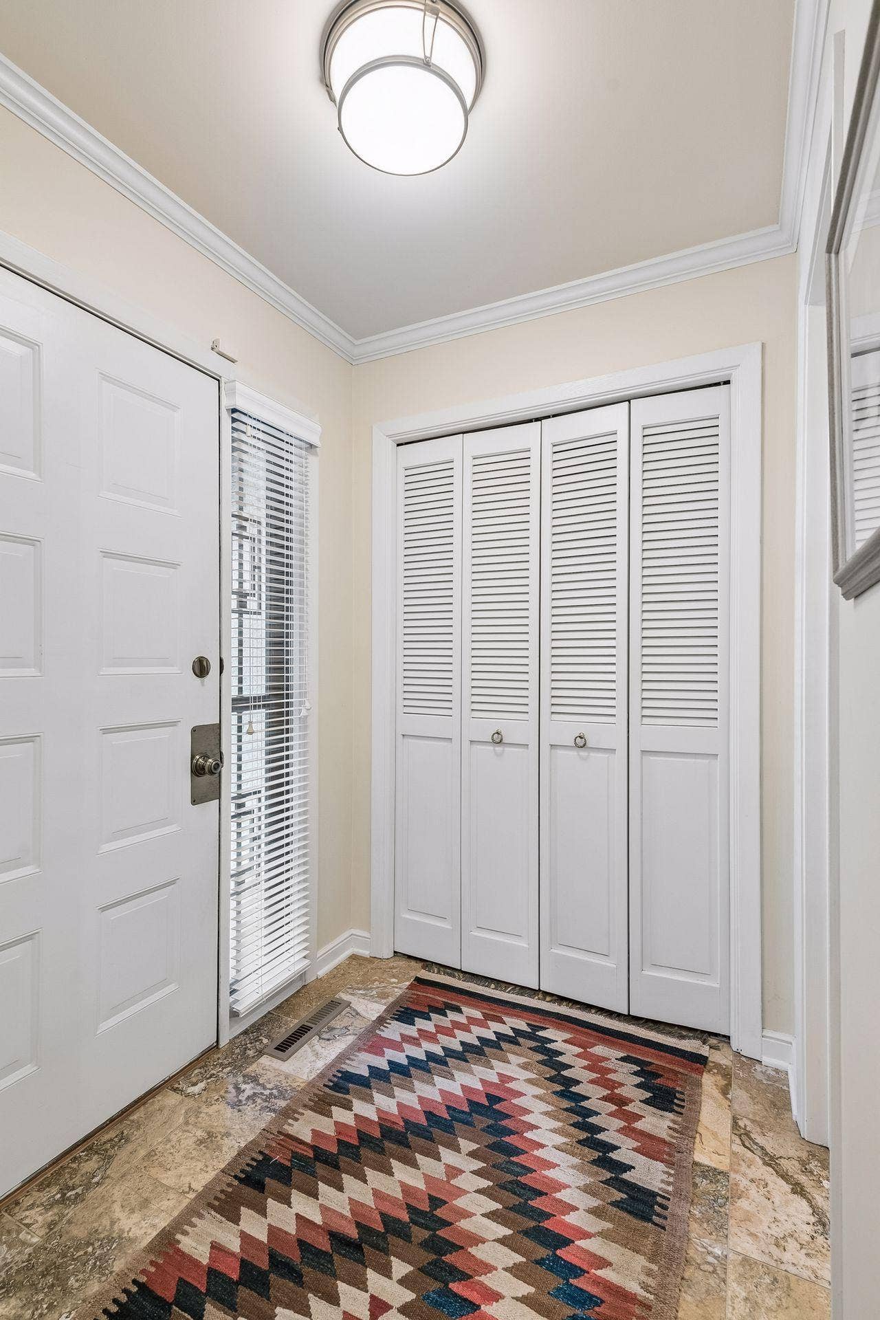 Foyer has a large closet for storage and easy access to the 1/2 bath.