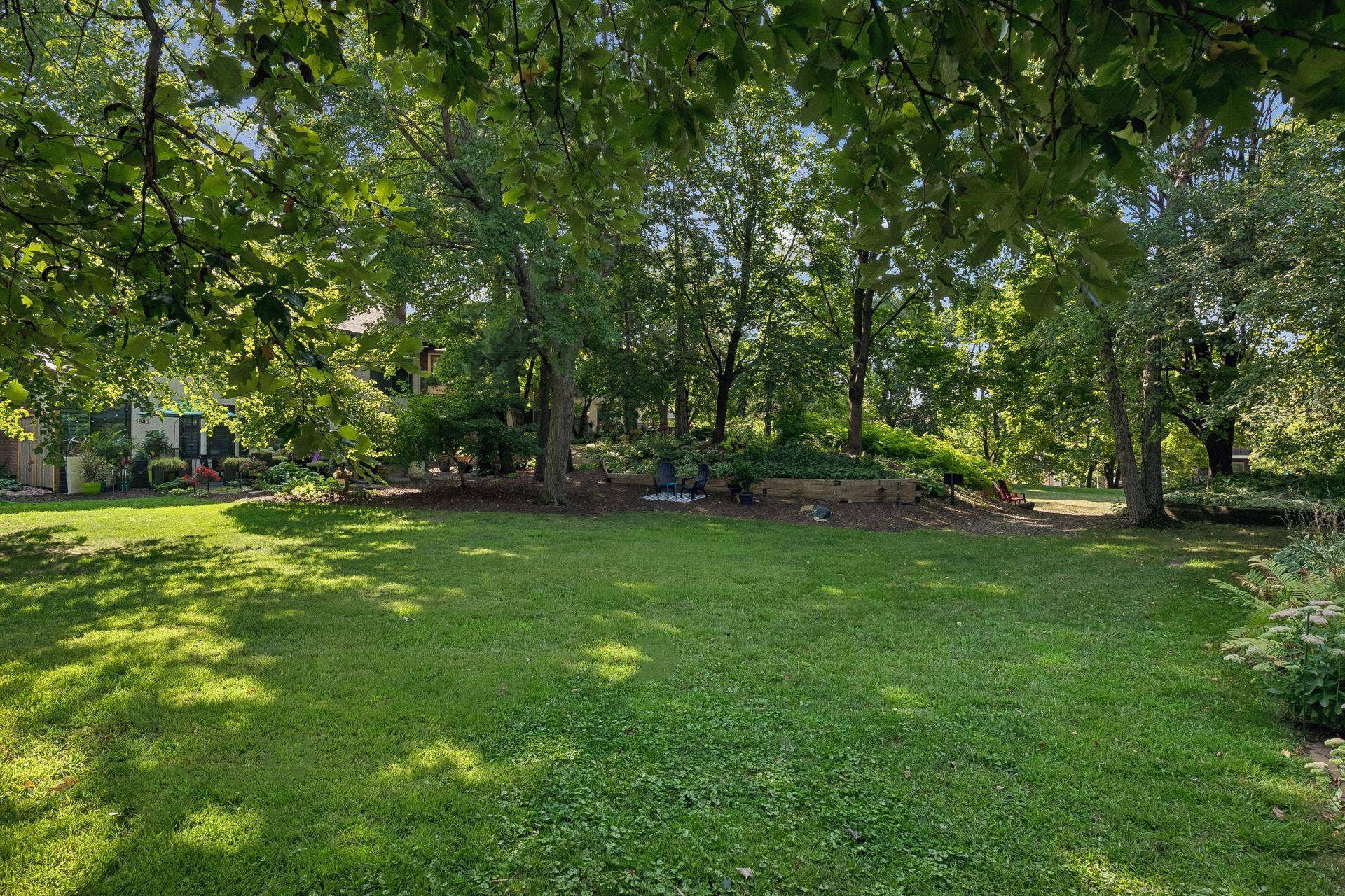 Lush greenery and trees provide a beautiful backdrop regardless of the season. An in-ground sprinkler system keeps the area inviting and ready for use!