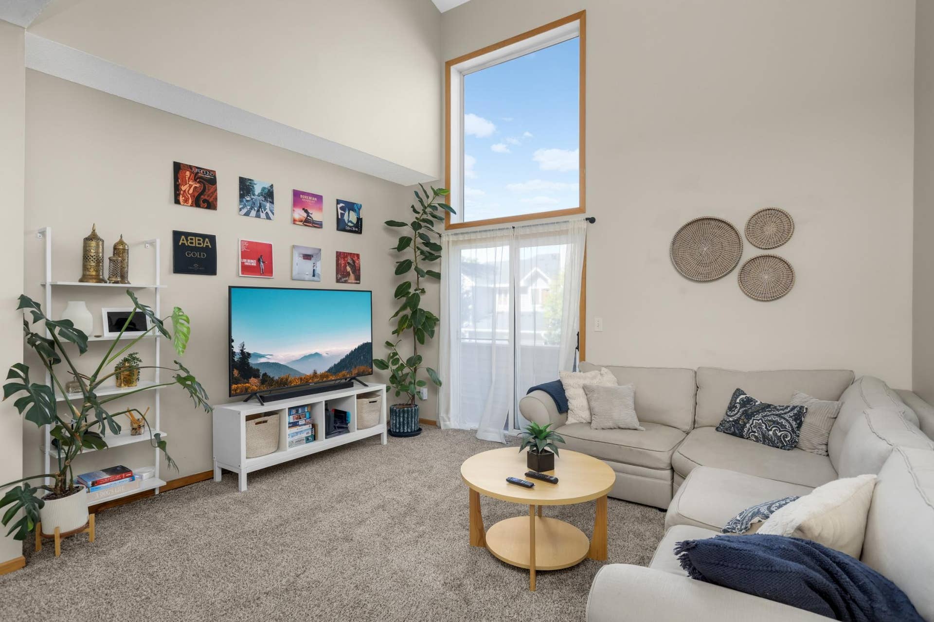Living room with vaulted ceilings and access to private deck