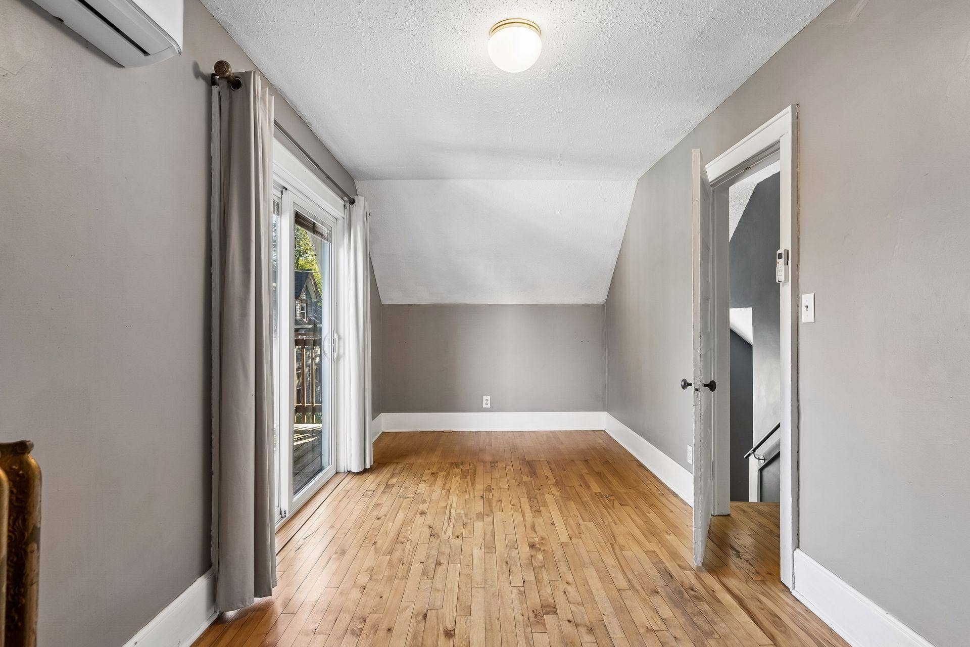 3112 E 33rd Street, 44, Minneapolis, MN 55406 Bedroom with a balcony? Yes, please! The second upper level bedroom features hardwood floors and overhead lighting. Sip morning coffee, read a book and relax or enjoy the weather on the private balcony through the sliding doors.