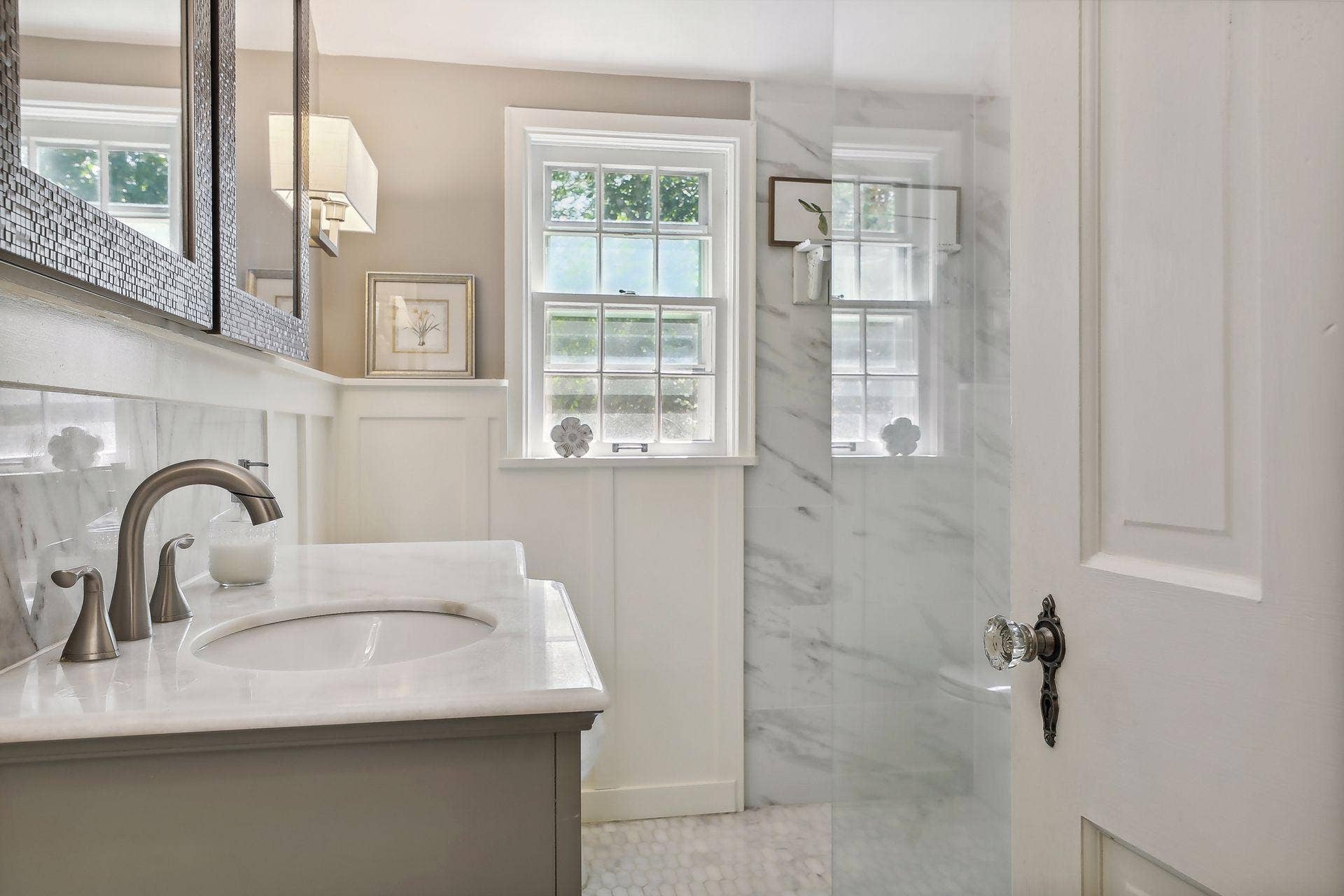 Stunning upper-level bathroom with glass walk-in shower.