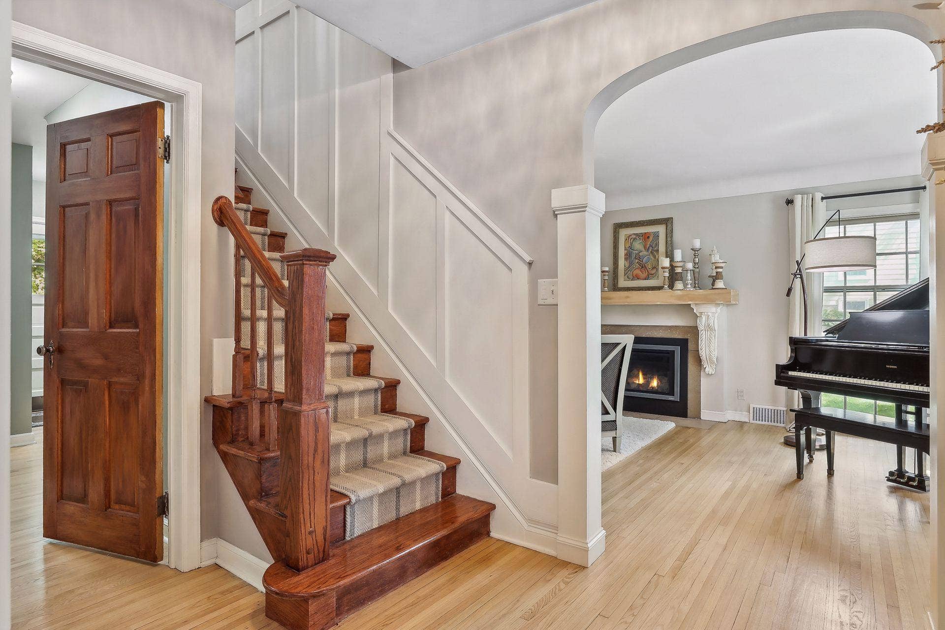 Elegant arched openings between living spaces and wainscoting.