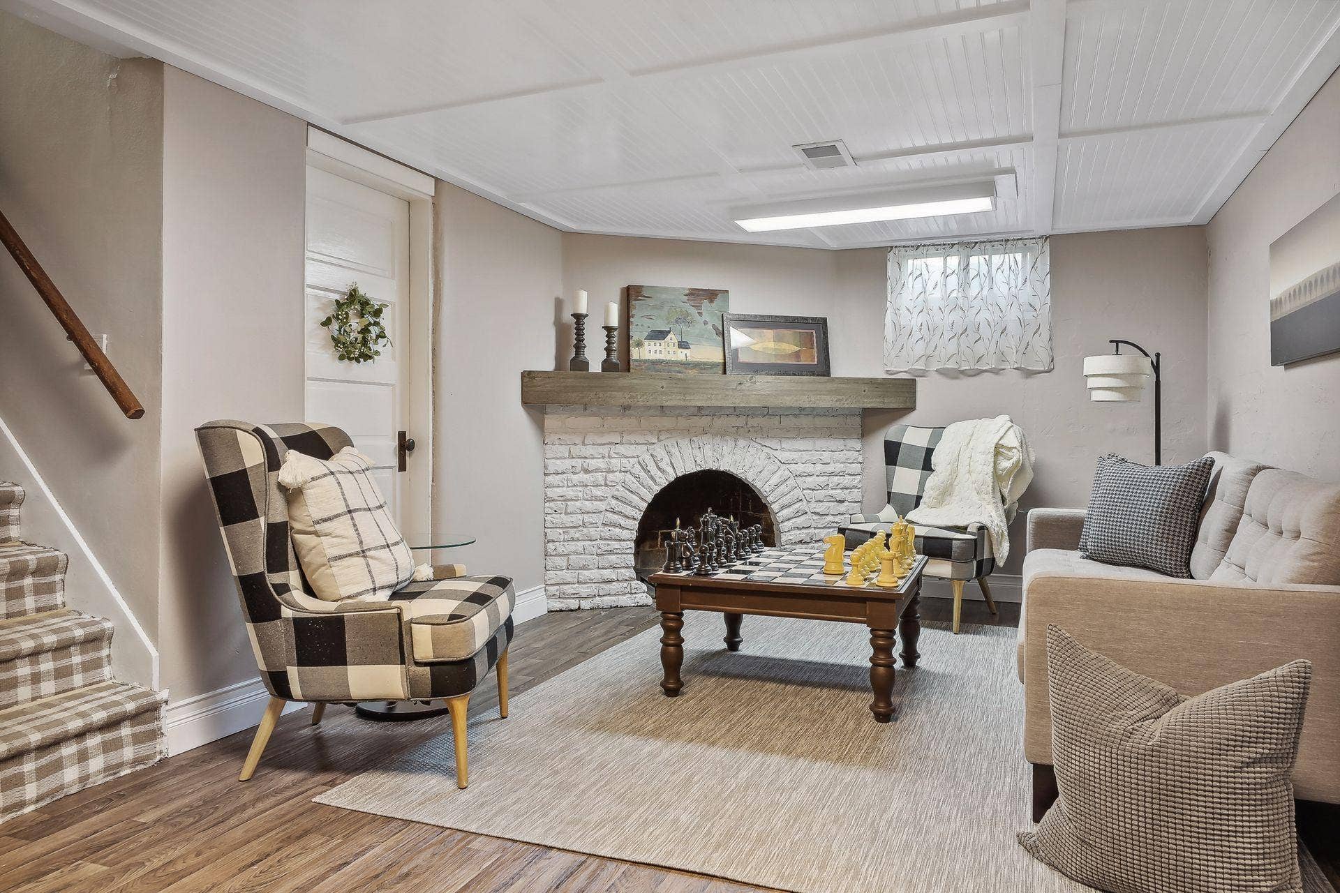 Lower-level family room offers functional fireplace