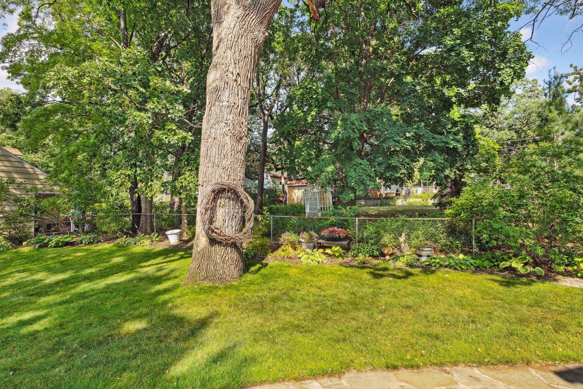 Well tended gardens and mature trees.
