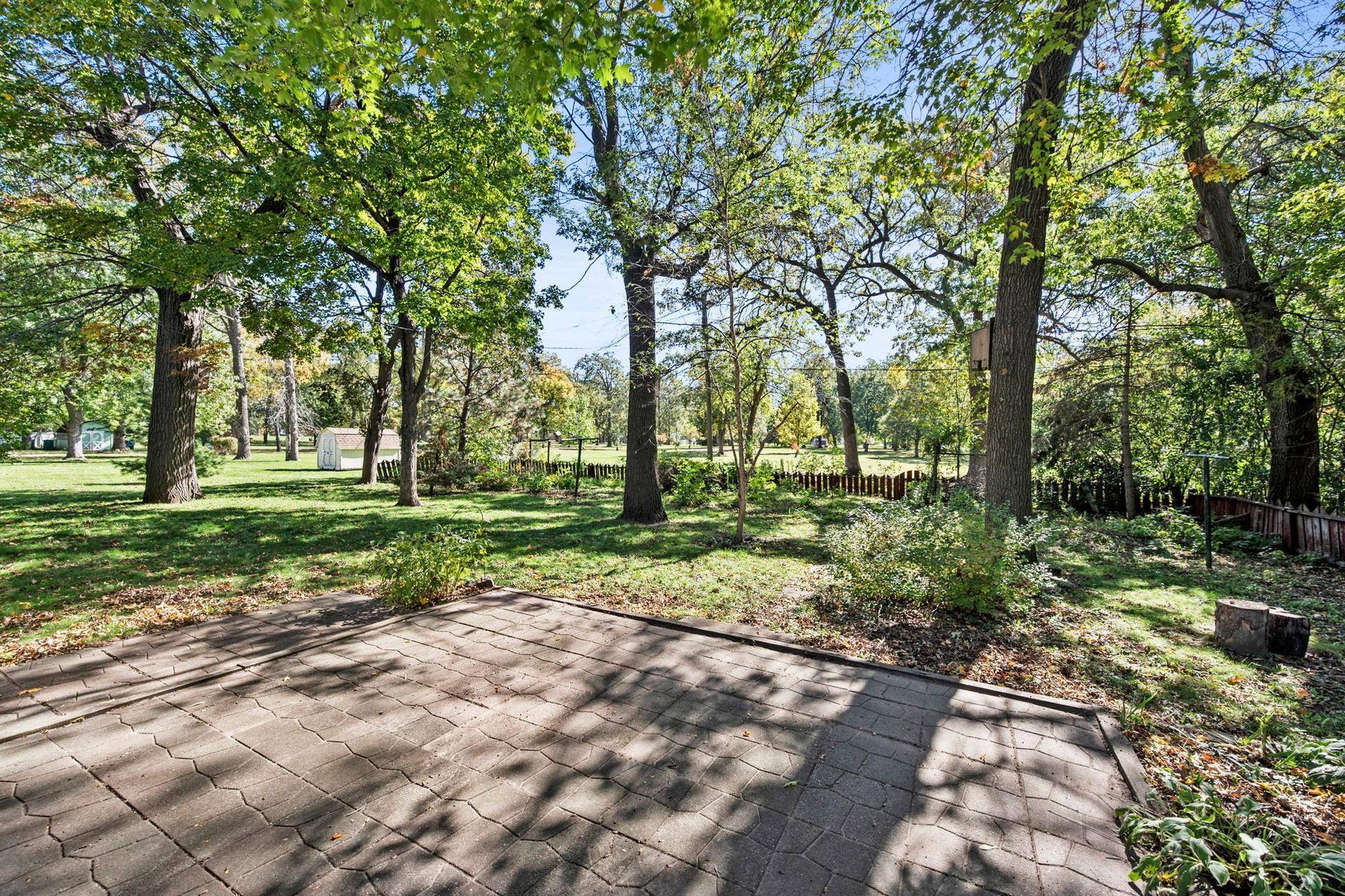6609 74th Avenue N, Brooklyn Park, MN 55428 A large paver patio and partially fenced yard provide a wonderful place to relax or entertain.