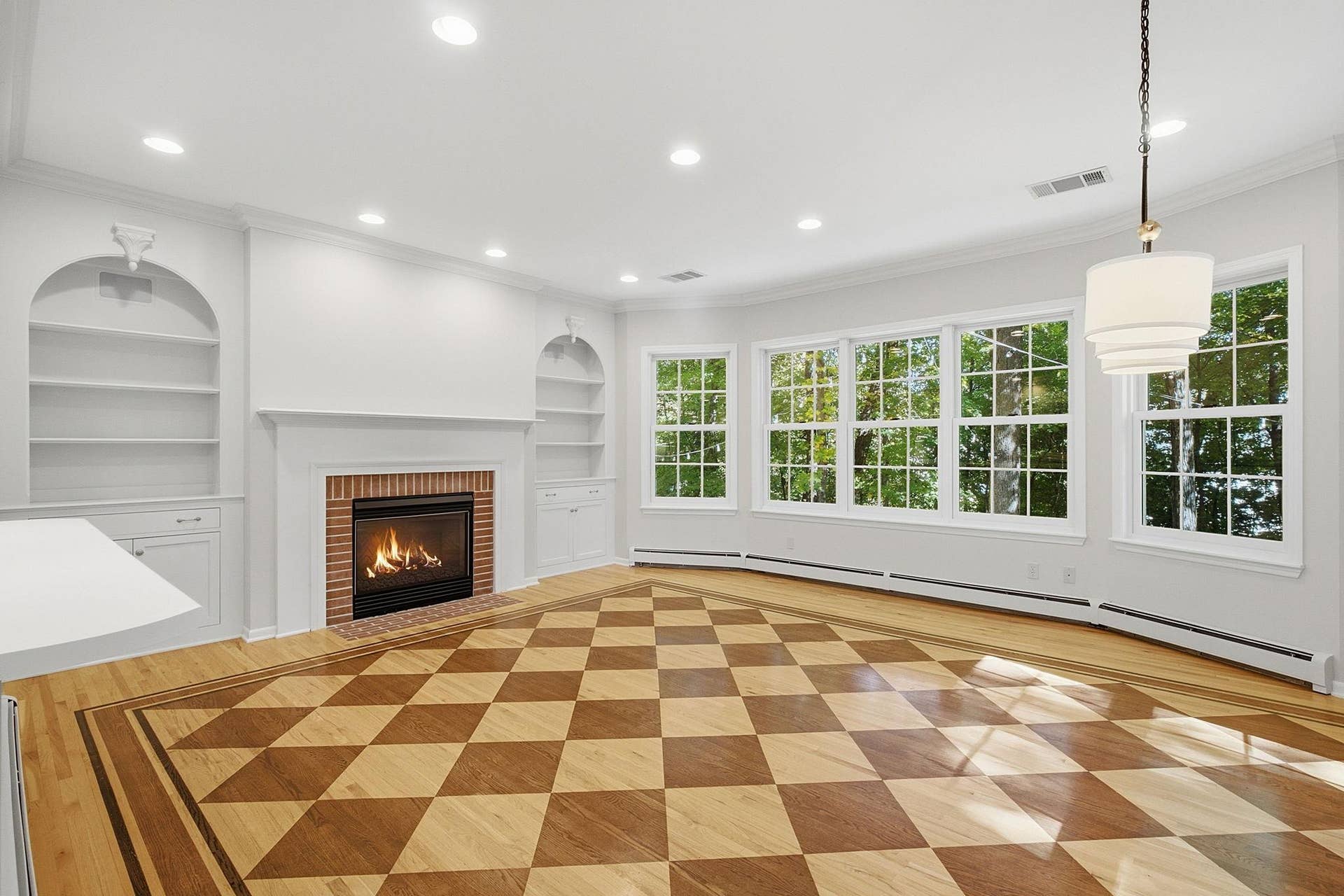 1330 Urbandale Lane N, Plymouth, MN 55447 Step over into the family room with checked wood floors, gas fireplace, and stunning views of the backyard