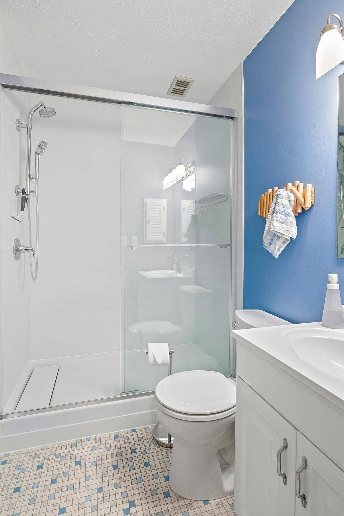 200 Mississippi River Boulevard N, #1C, 96, Saint Paul, MN 55104 Bright and fresh bathroom with new shower (2026), mid-century tile and updated vanity.