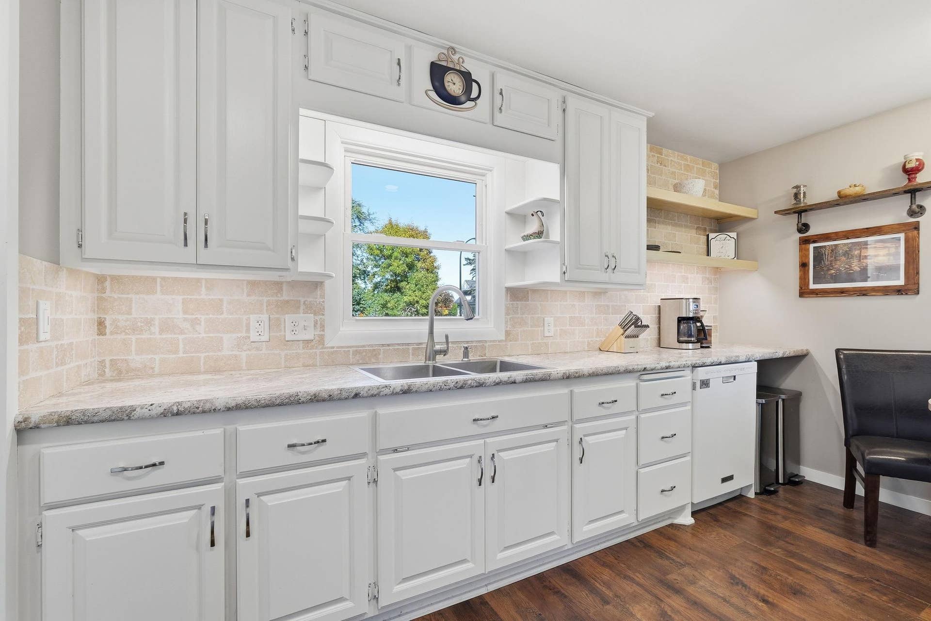 611 Central Avenue, Buffalo, MN 55313 Remodeled kitchen features bright white cabinets and a large window over the sink.