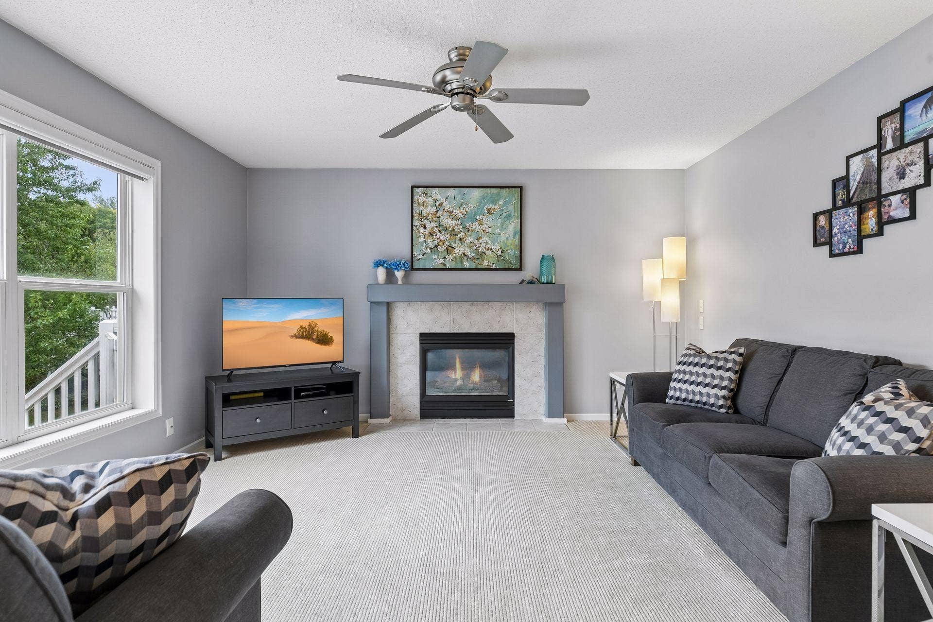 957 Lake Ridge Bay, Woodbury, MN 55129 A gas fireplace creates a warm focal point in the spacious family room, complemented by carpet flooring, a ceiling fan, large windows, and ample room for relaxing or entertaining.